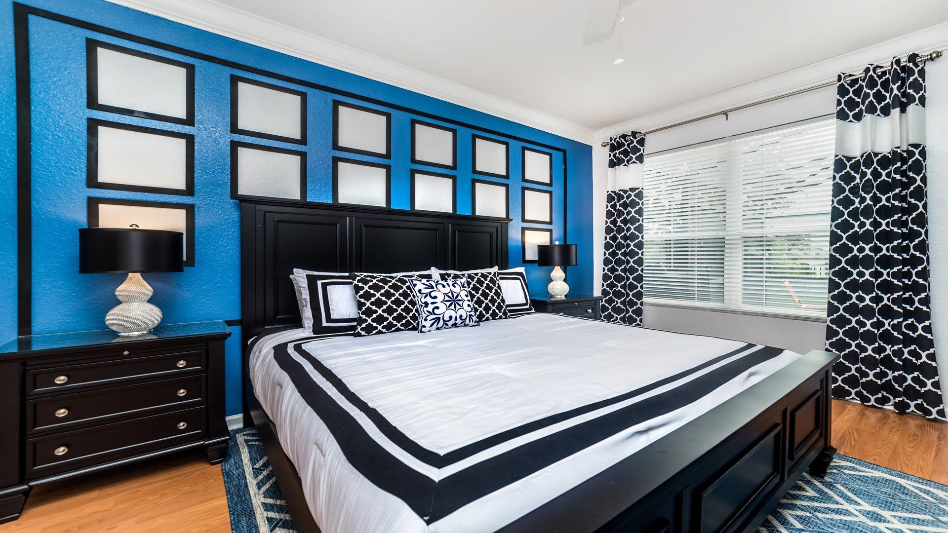 Bold and stylish bedroom with a luxe king bed, modern decor, and vibrant accents.