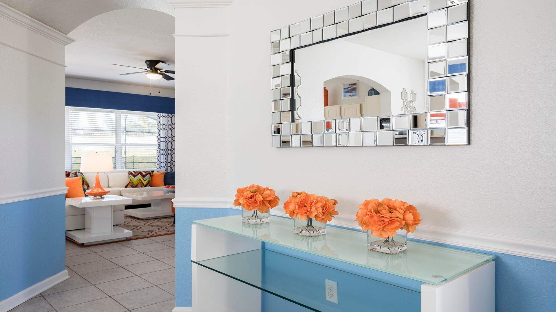 Bright and stylish entryway with modern decor and a peek into the cozy living room.