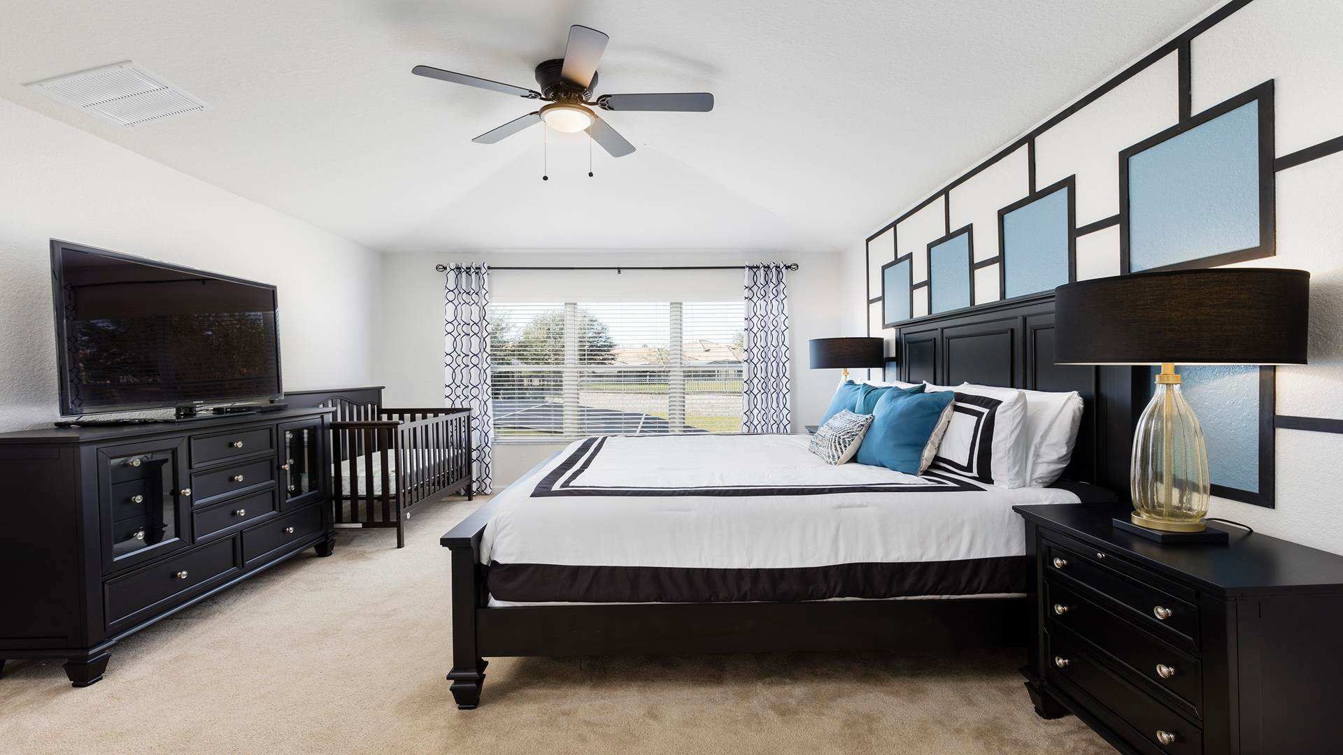 The master bedroom on the ground floor with a luxuriously large king bed