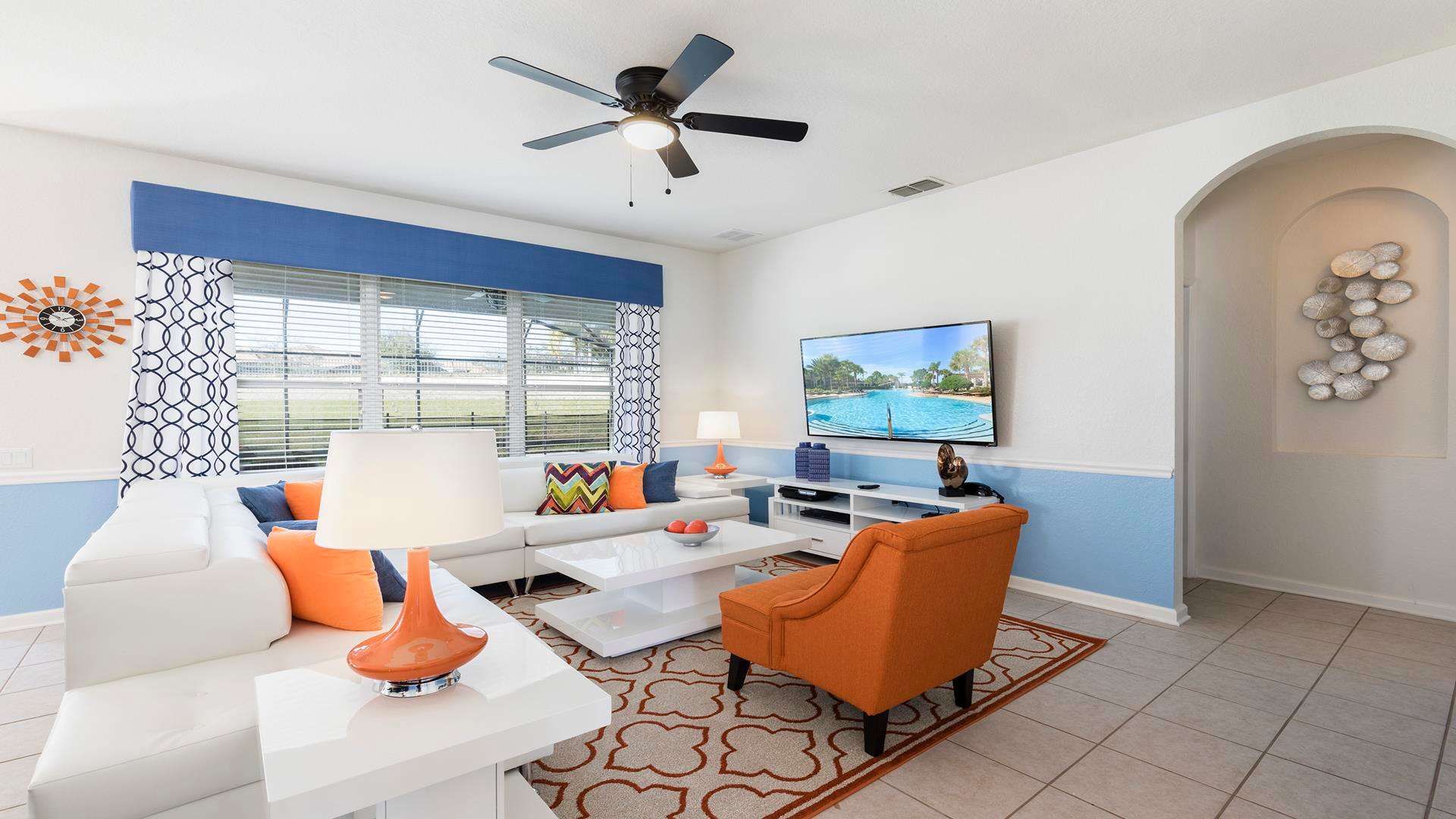 This bright living room boasts comfy seating, a mounted TV for movie marathons, and large windows for soaking up the sun. Relax and unwind in style!