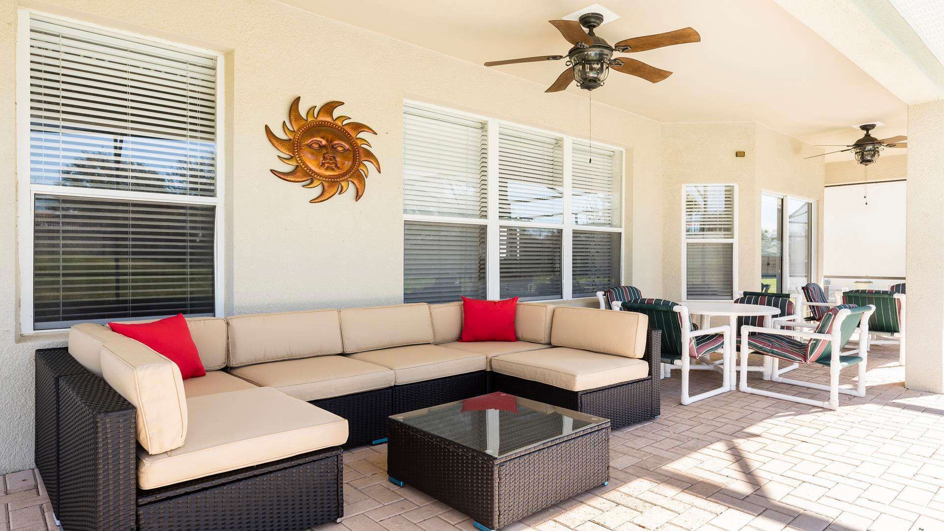 Relax on this spacious covered patio with cozy seating and outdoor dining.