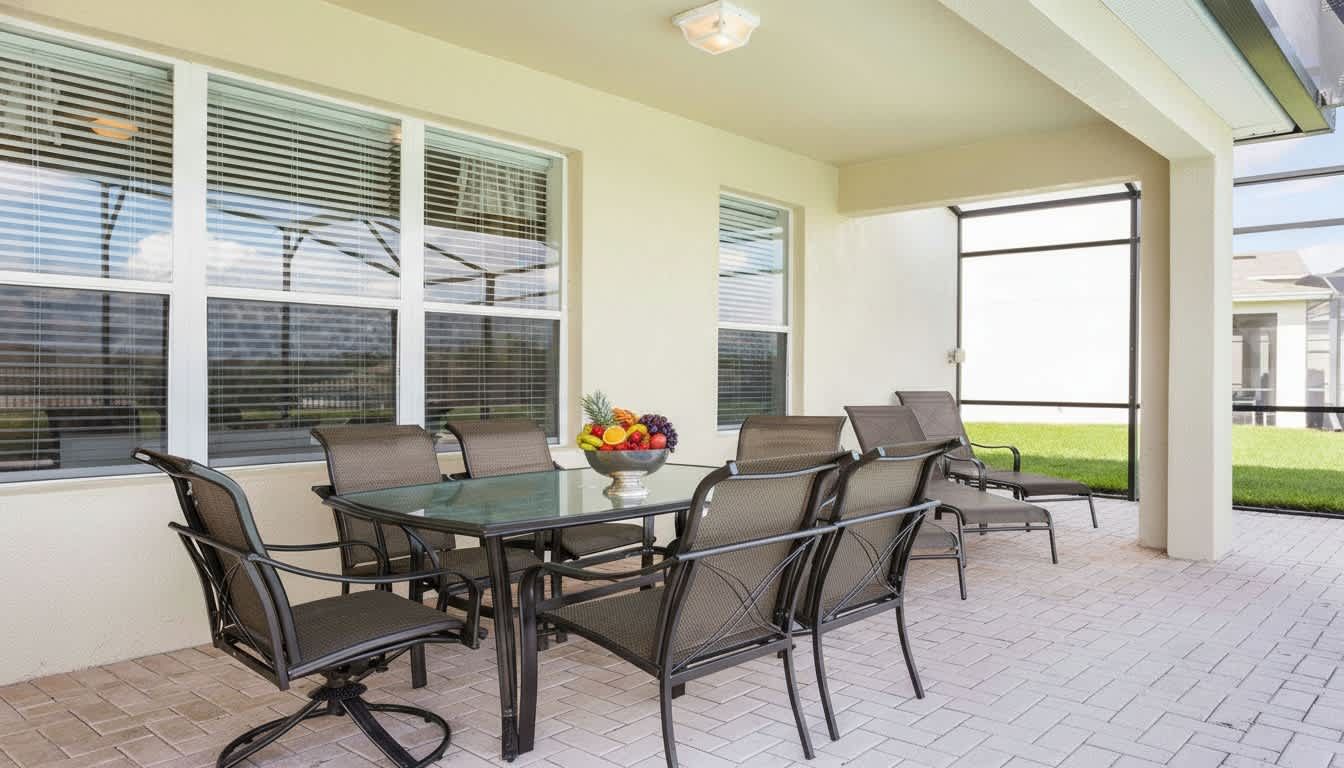 Covered patio with ample seating, perfect for outdoor dining and relaxing by the pool.