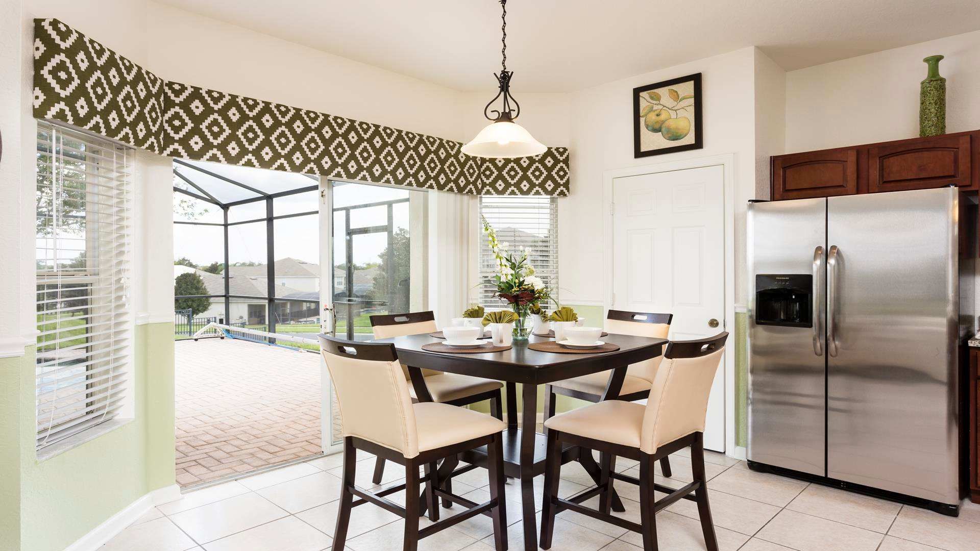 Bright and inviting breakfast nook with poolside views, perfect for morning coffee.