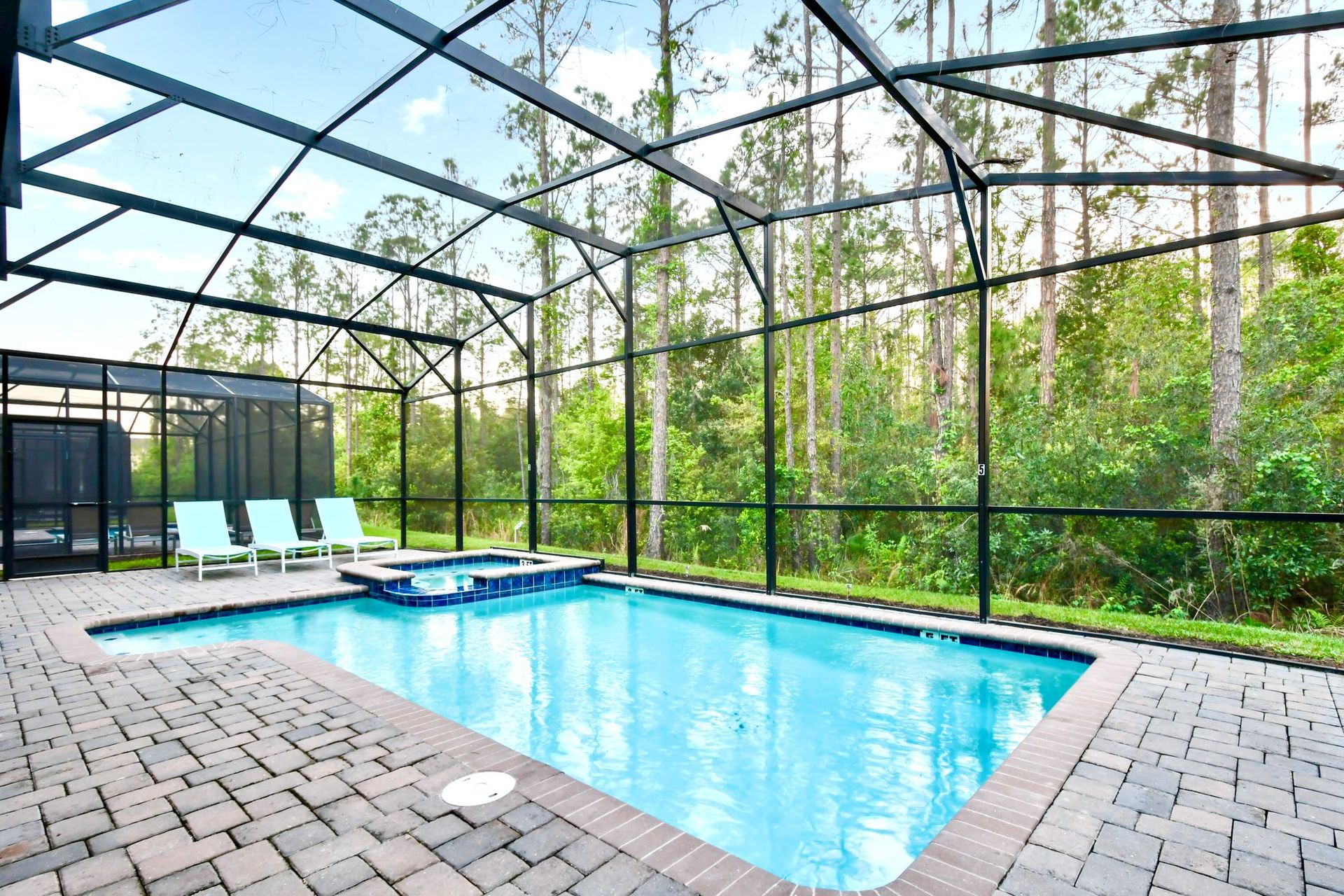 Relax in a private screened pool and spa, surrounded by serene nature views.