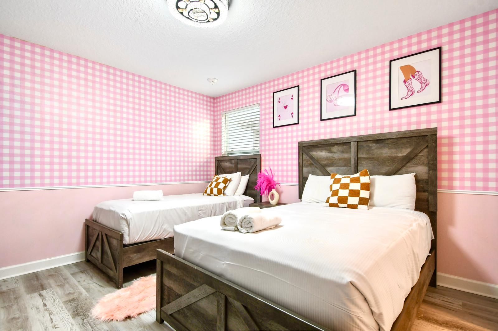 Charming pink-themed bedroom with rustic wood beds, cozy decor, and playful accents.
