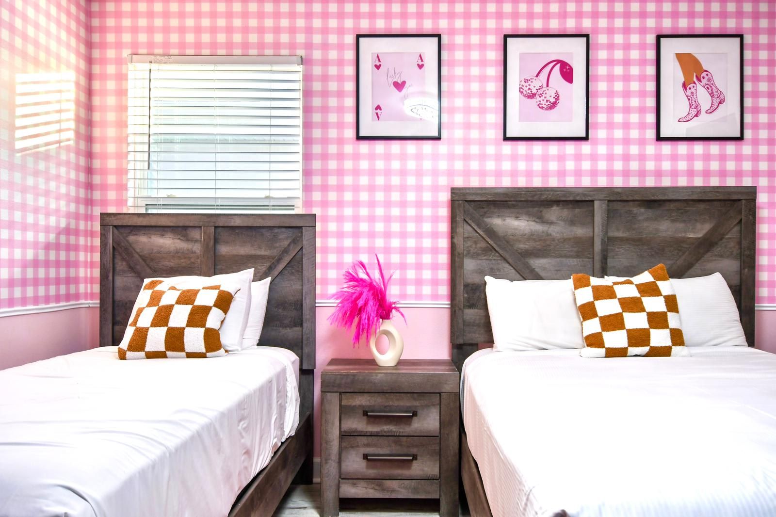 Chic pink-themed bedroom with rustic wood beds, playful decor, and cozy accents.