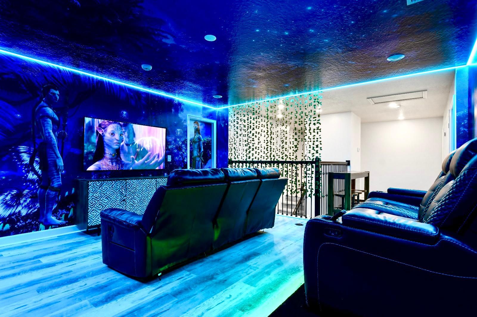 Immersive Avatar-themed home theater with glowing LED lights and cozy recliner seating.