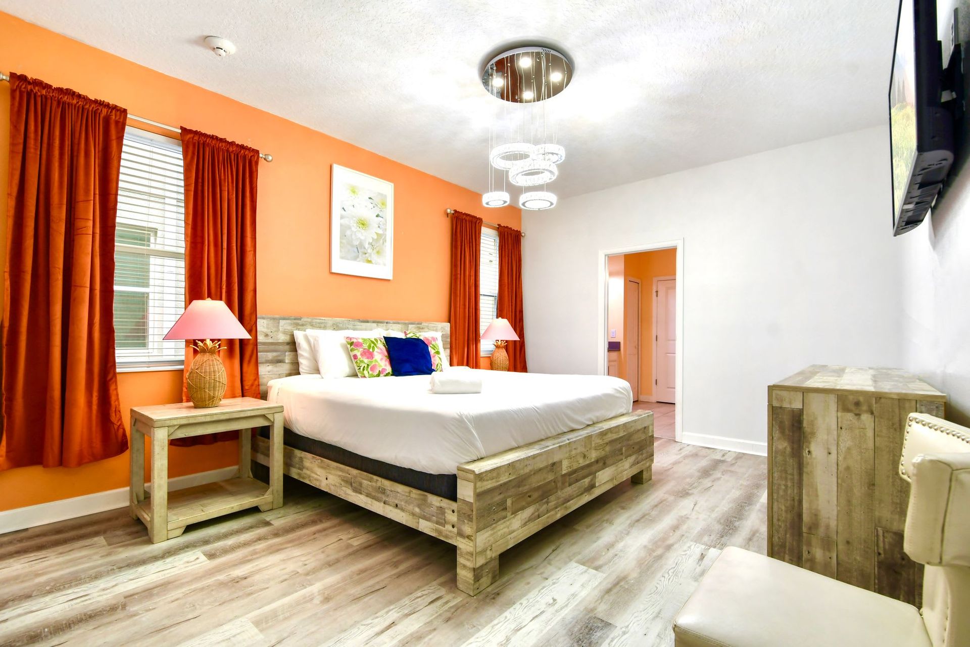 Bright and cozy bedroom with rustic wood furniture, warm tones, and modern lighting.