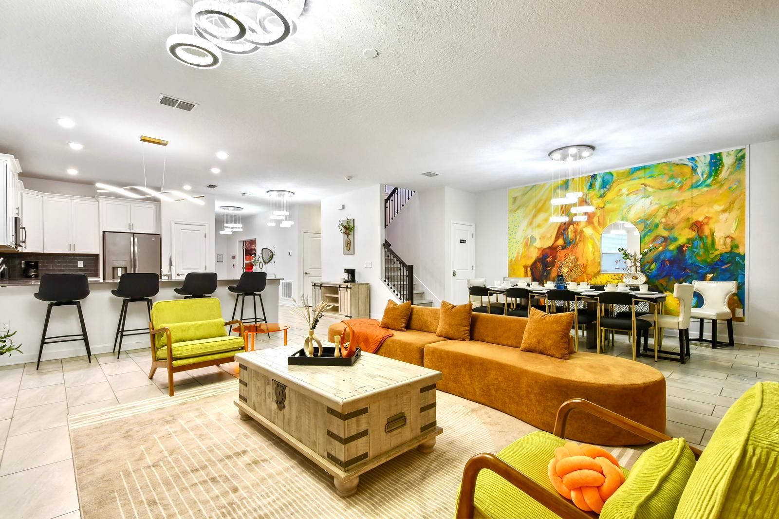 Spacious open-concept home with modern decor, vibrant accents, and cozy seating.