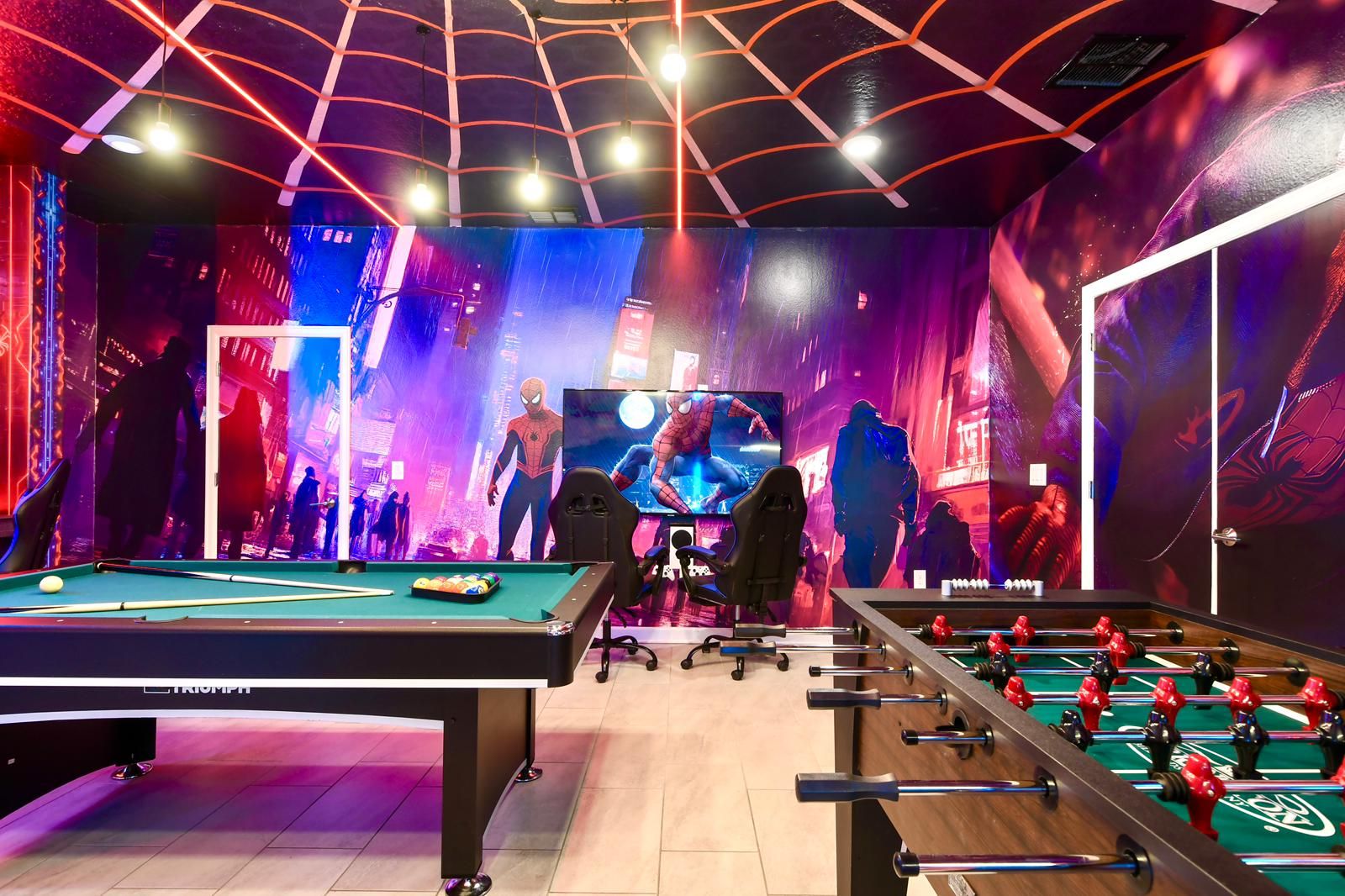 Action-packed Spider-Man game room with gaming stations, pool table, and foosball.