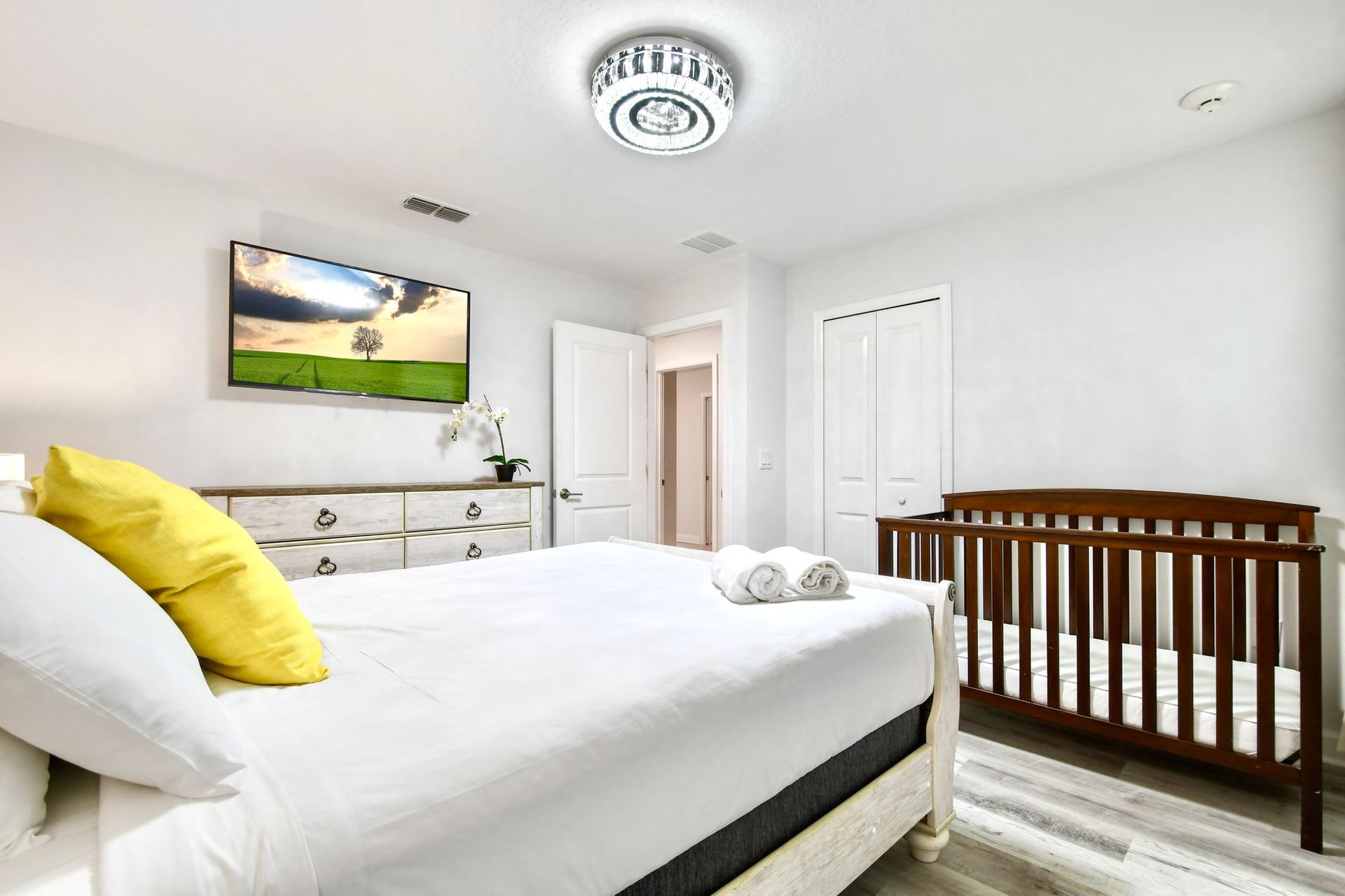 Bright and cozy bedroom with a crib, elegant decor, and a warm, family-friendly feel.