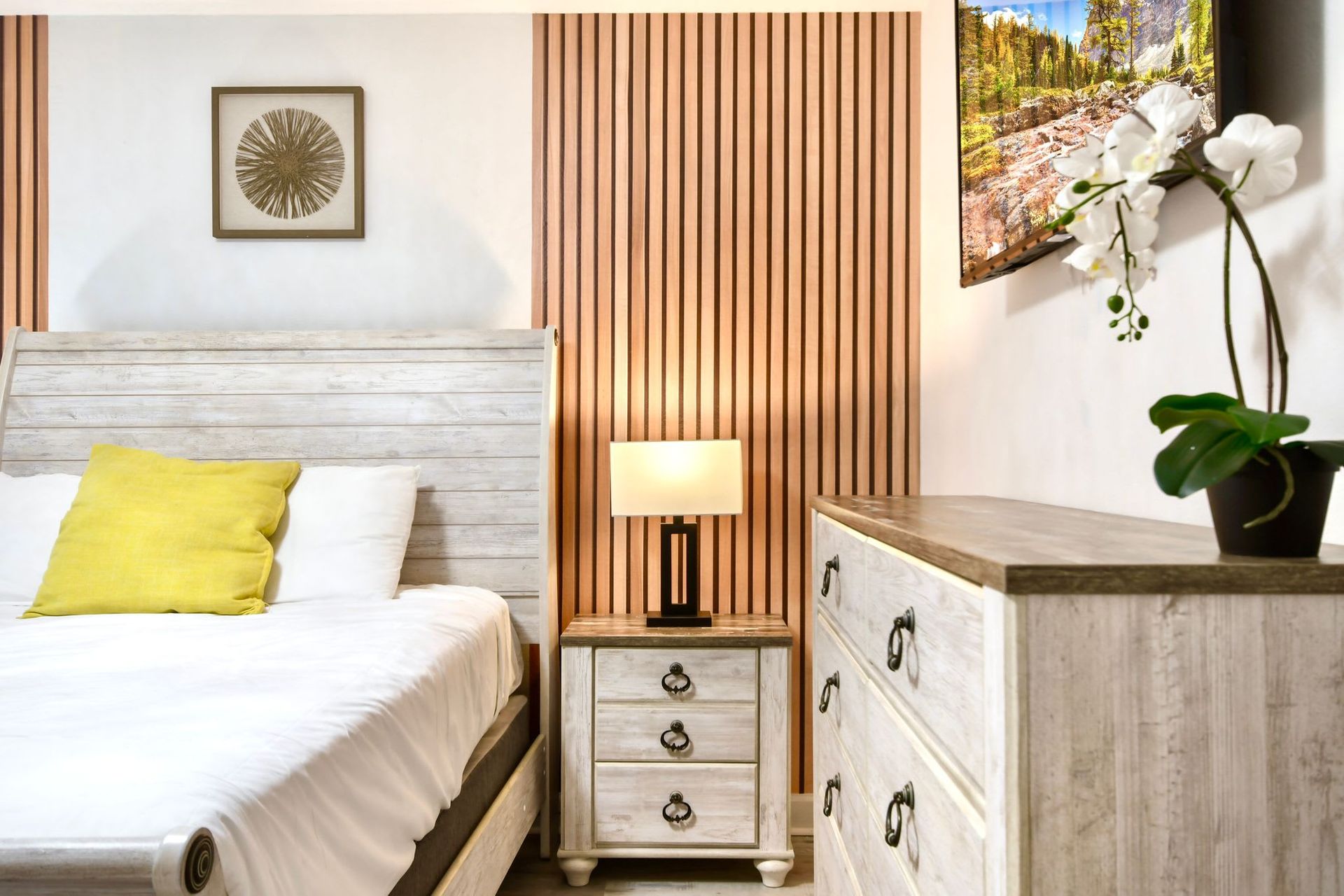 Stylish bedroom with rustic wood furniture, warm accents, and a cozy modern touch.