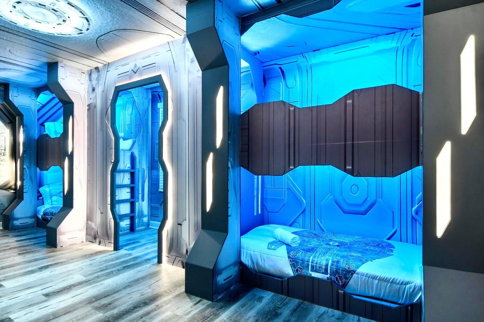 Futuristic Star Wars-themed bunk room with glowing blue lighting and immersive design.