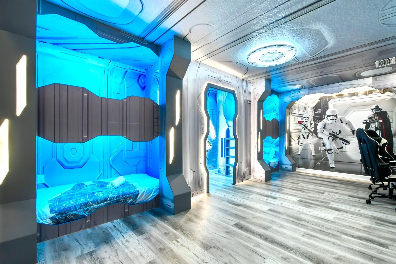 Futuristic Star Wars-themed bedroom with glowing bunk beds and an epic gaming setup.
