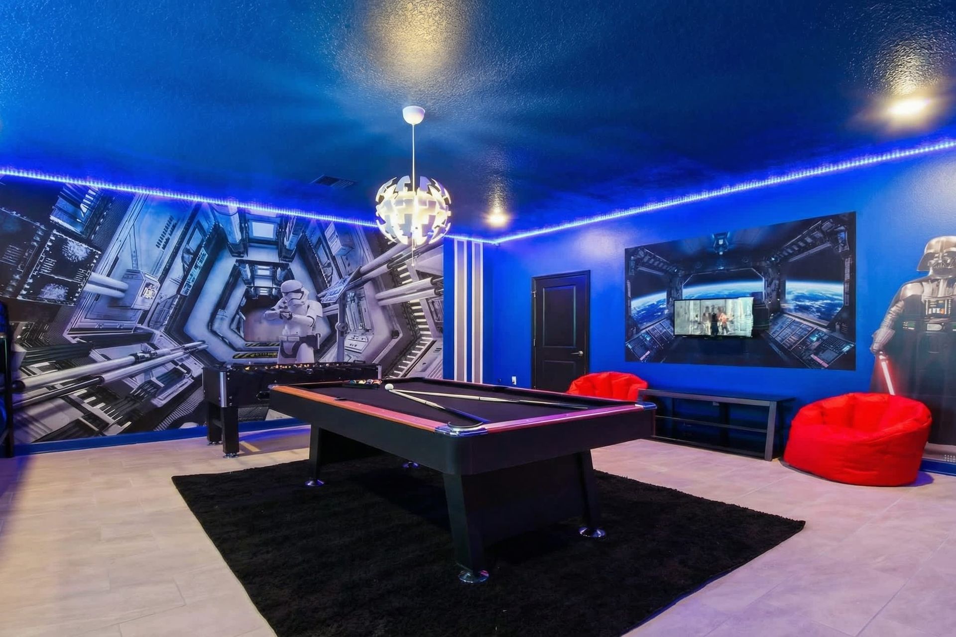 The game room bedroom is impeccably furnished with a Star Wars theme, enhanced by cool lights, creating a unique and captivating ambiance.