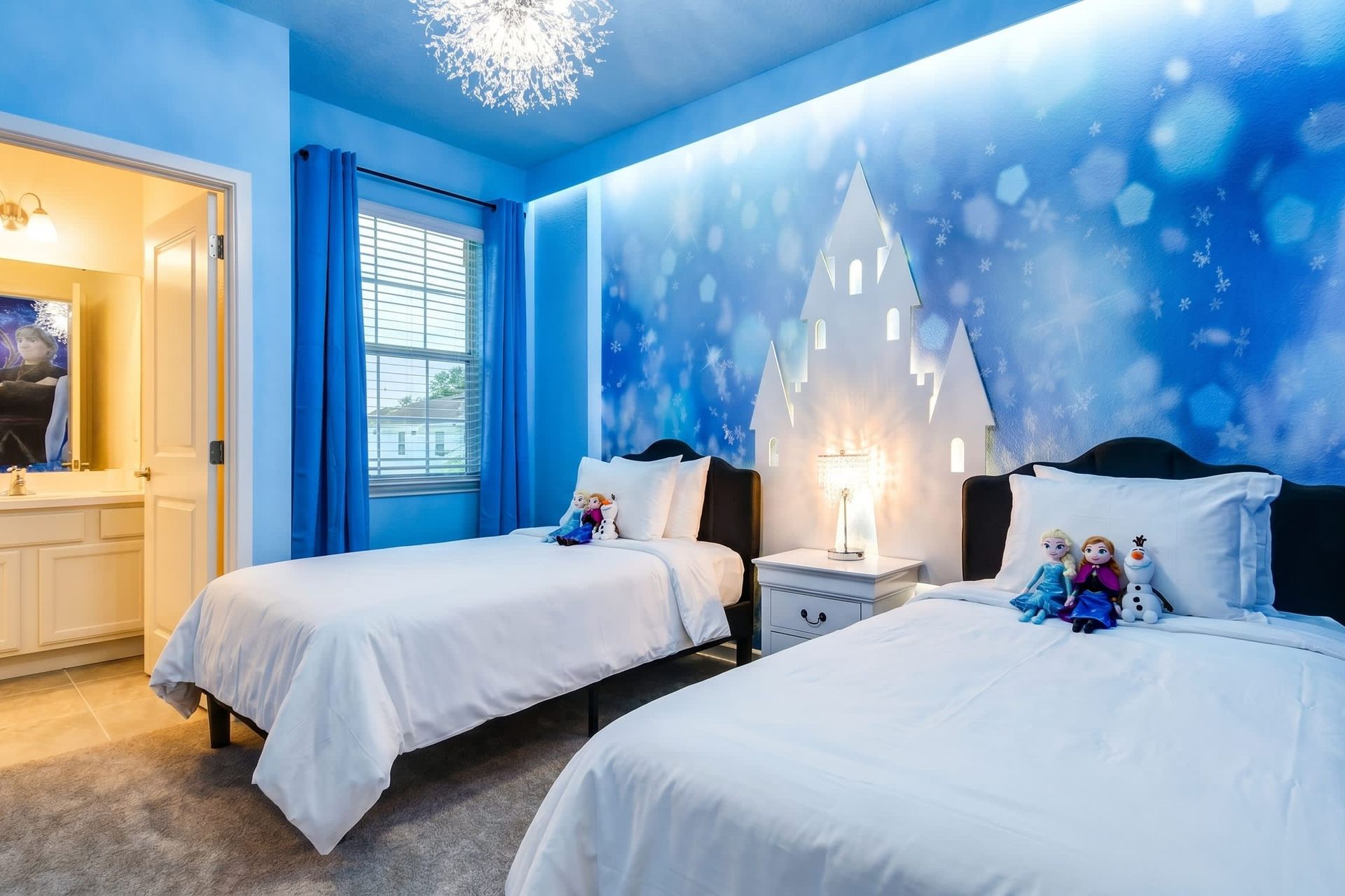 Frozen-themed bedroom with snowflake lighting and castle decor—magical for kids