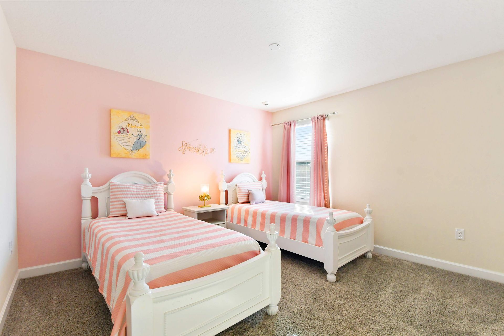 Charming princess-themed bedroom with twin beds, soft pink decor, and cozy elegance