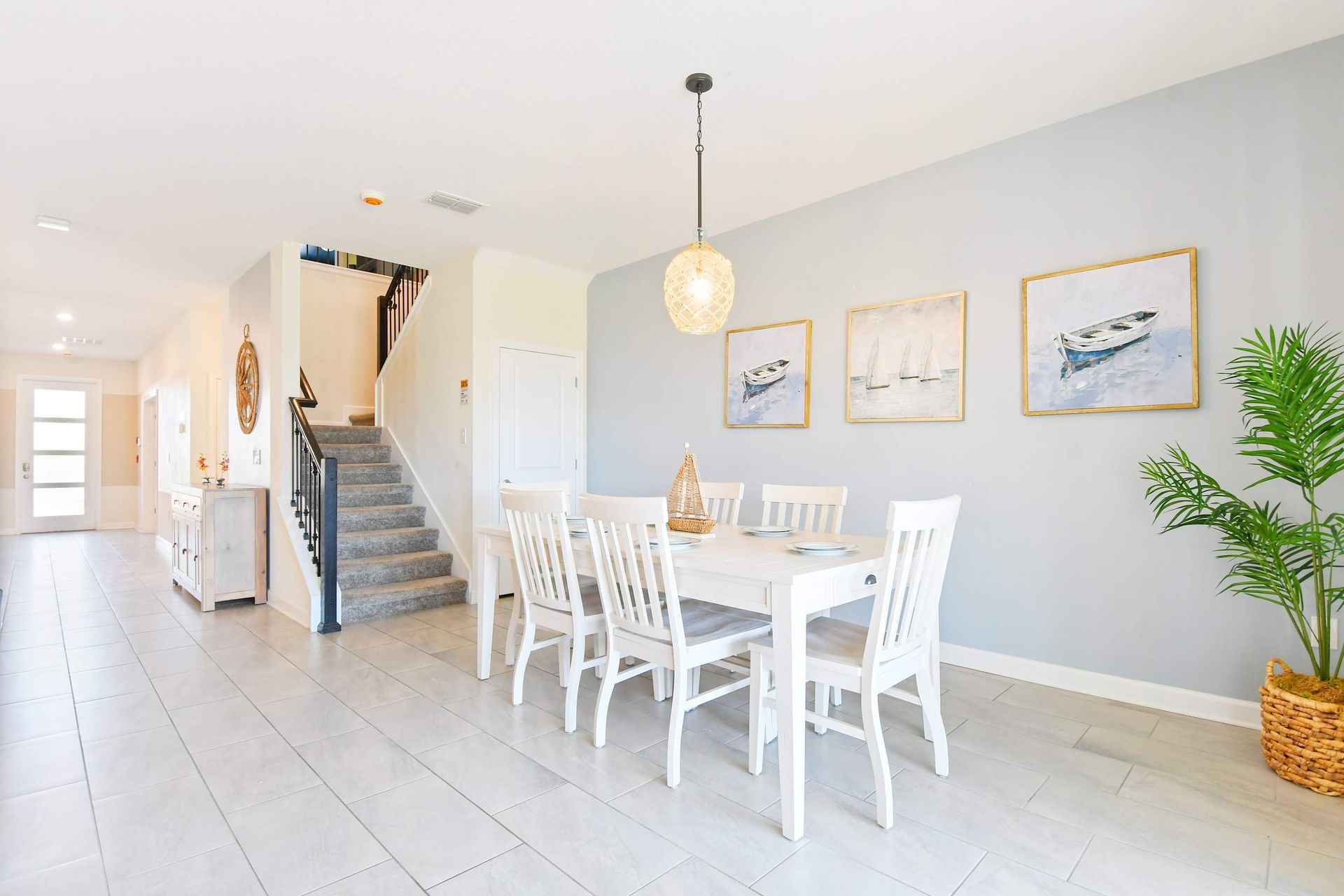 Bright coastal dining area with elegant decor, seating for six, and a stylish vibe