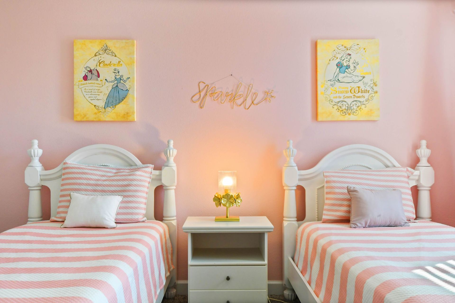 Charming princess-themed bedroom with twin beds, soft pink decor, and cozy elegance