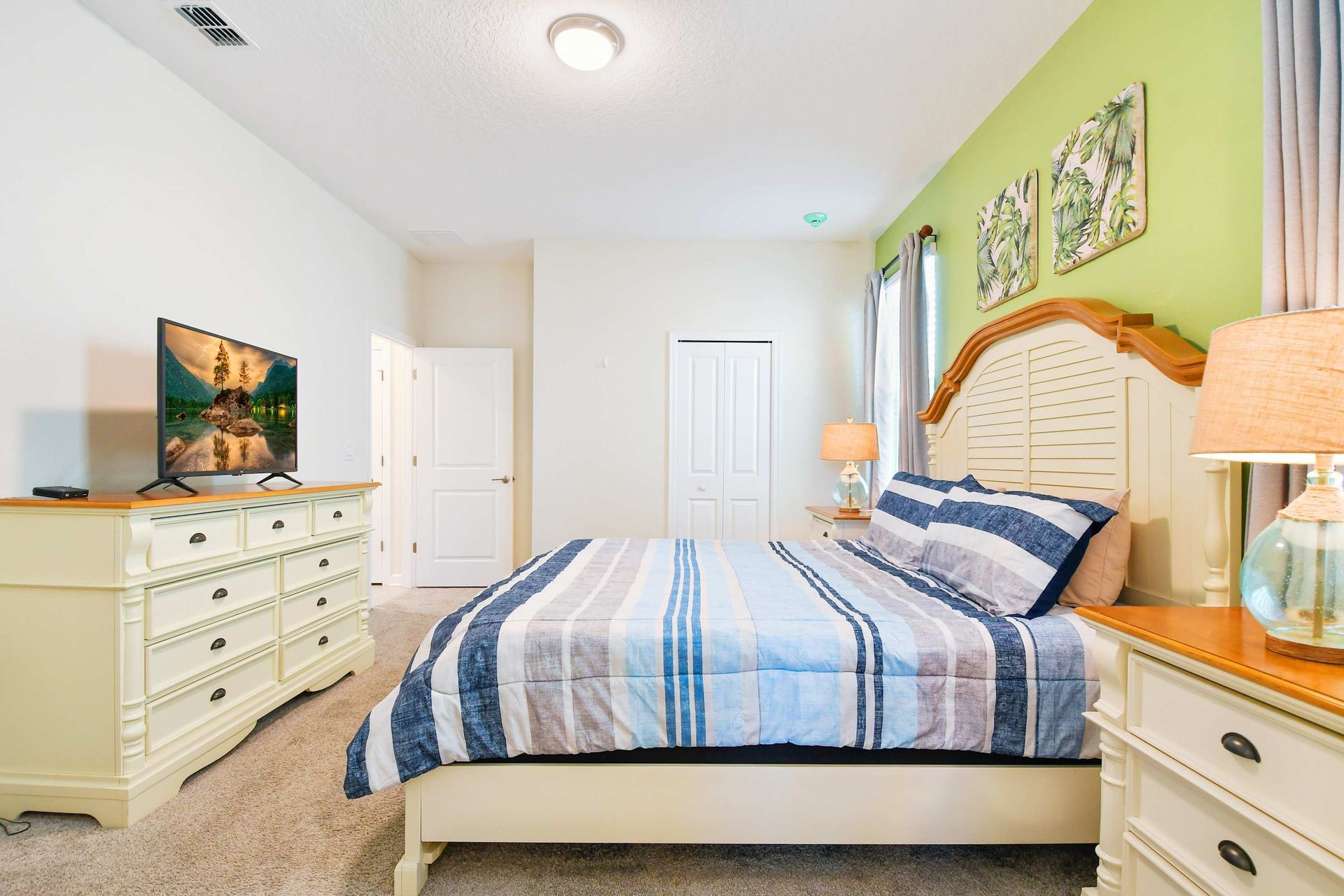 Tropical-style bedroom with en-suite bath and cozy, relaxing vibe.
