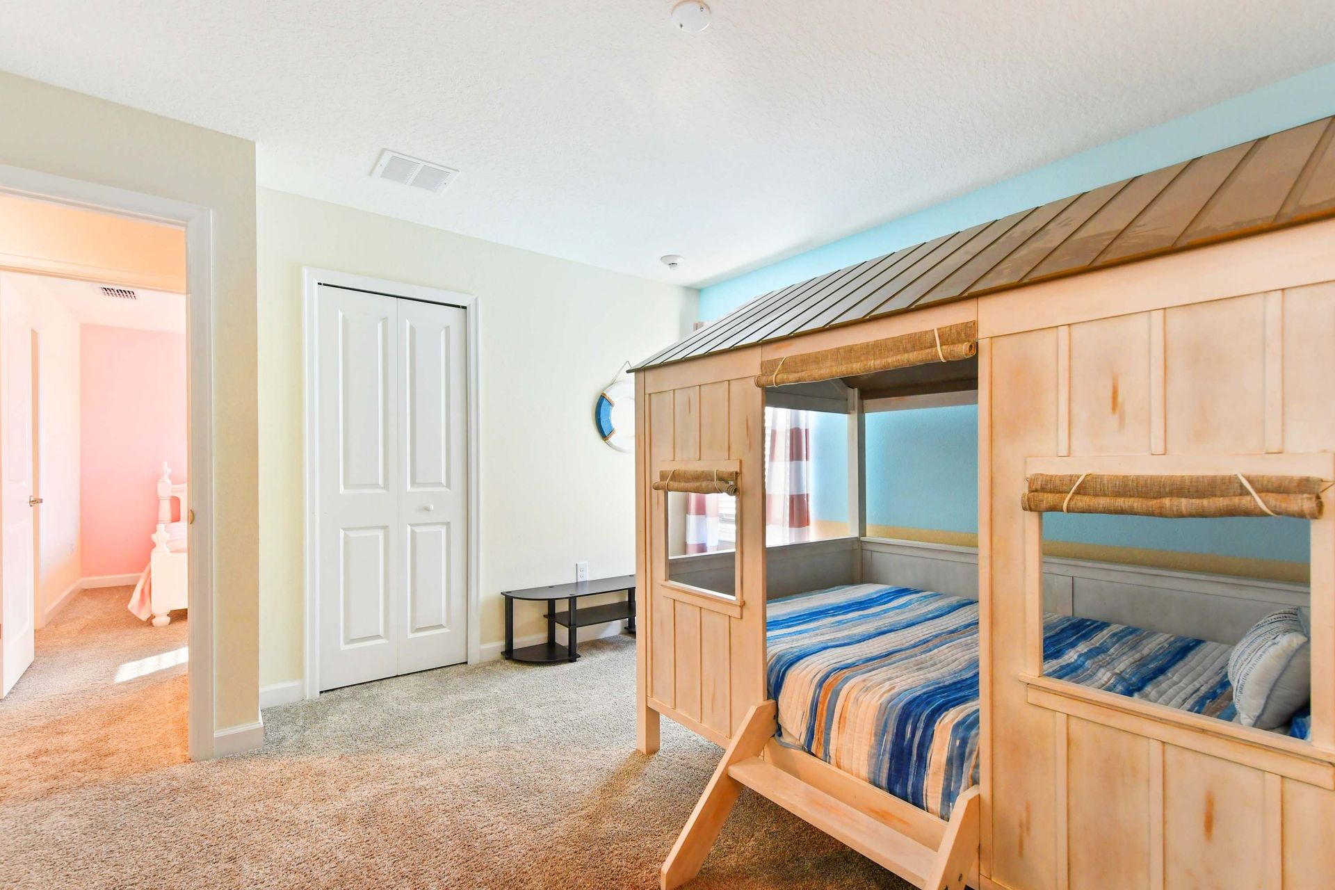 Whimsical beach-themed kids' room with a cozy bunk bed and playful coastal decor