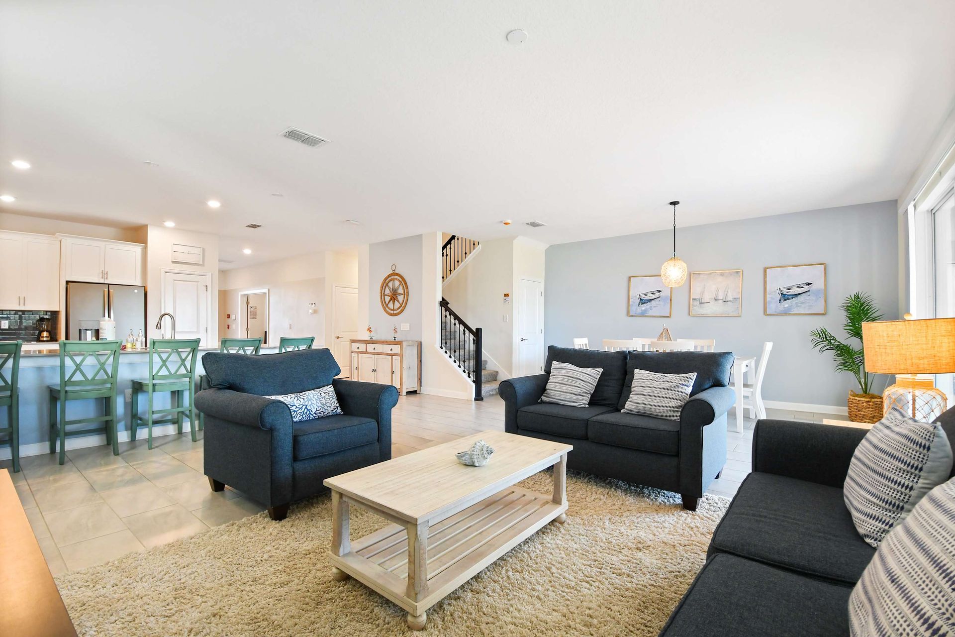 Bright coastal-style living space with open layout, cozy seating, and modern decor