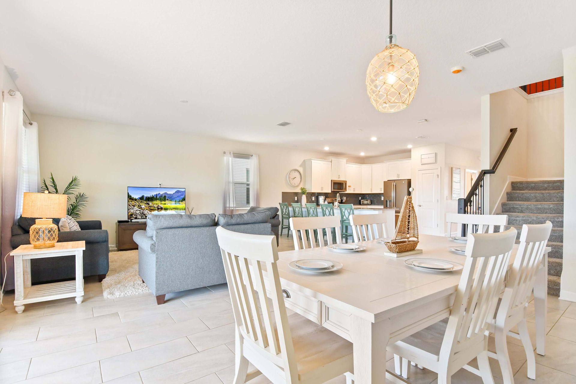 Elegant open-concept dining and living area with coastal charm and modern touches