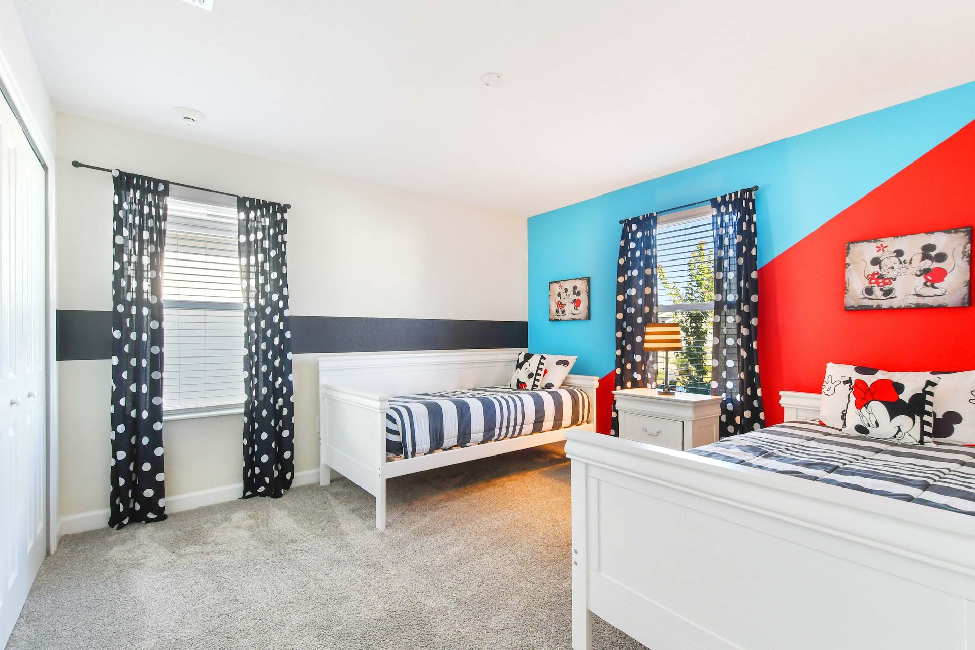Playful Disney-themed bedroom with twin beds, vibrant decor, and cozy charm