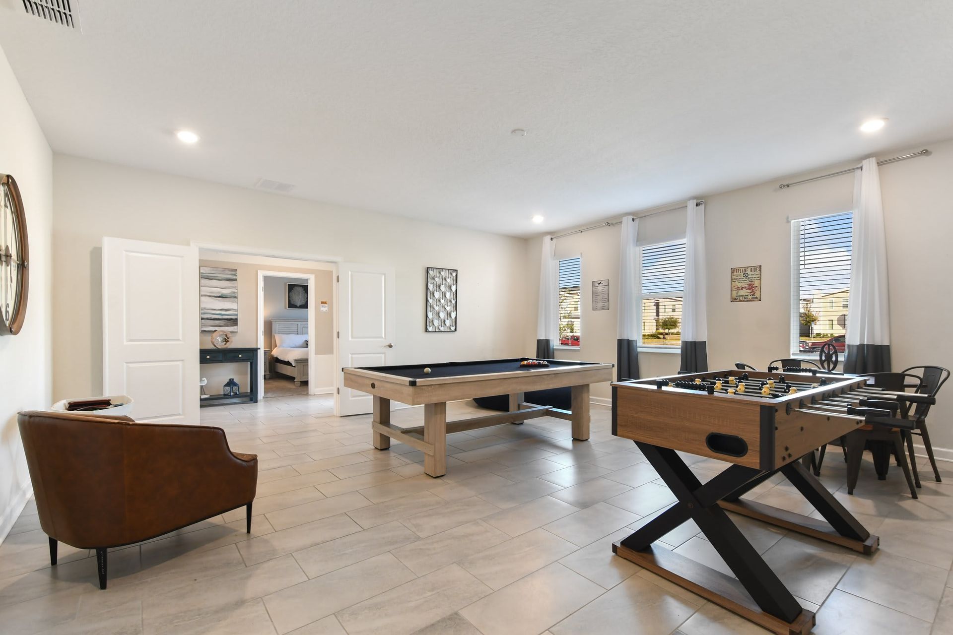 Spacious game room with pool table, foosball, and stylish seating for endless fun