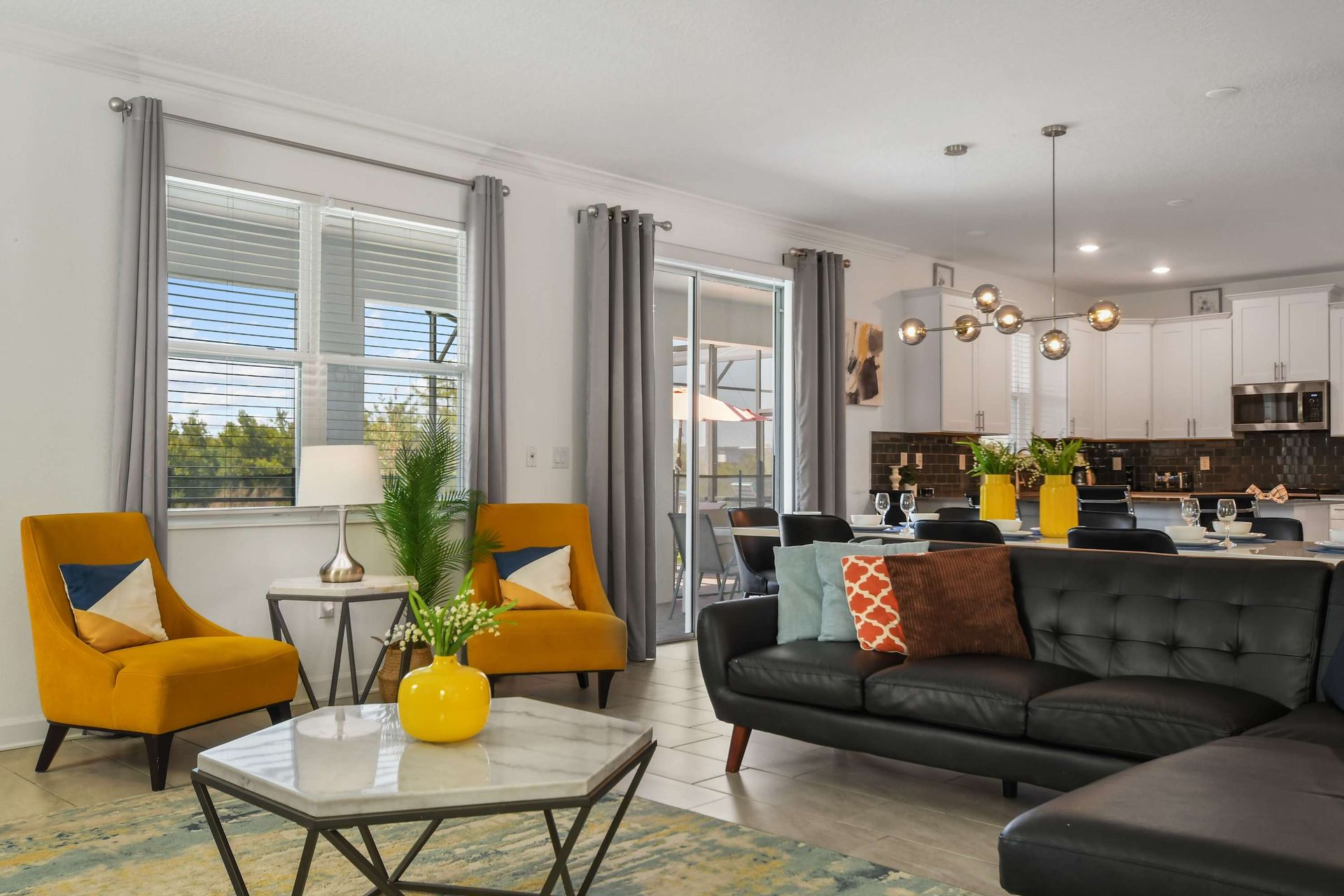 Modern open-concept living space with stylish seating, chic decor, and natural light.