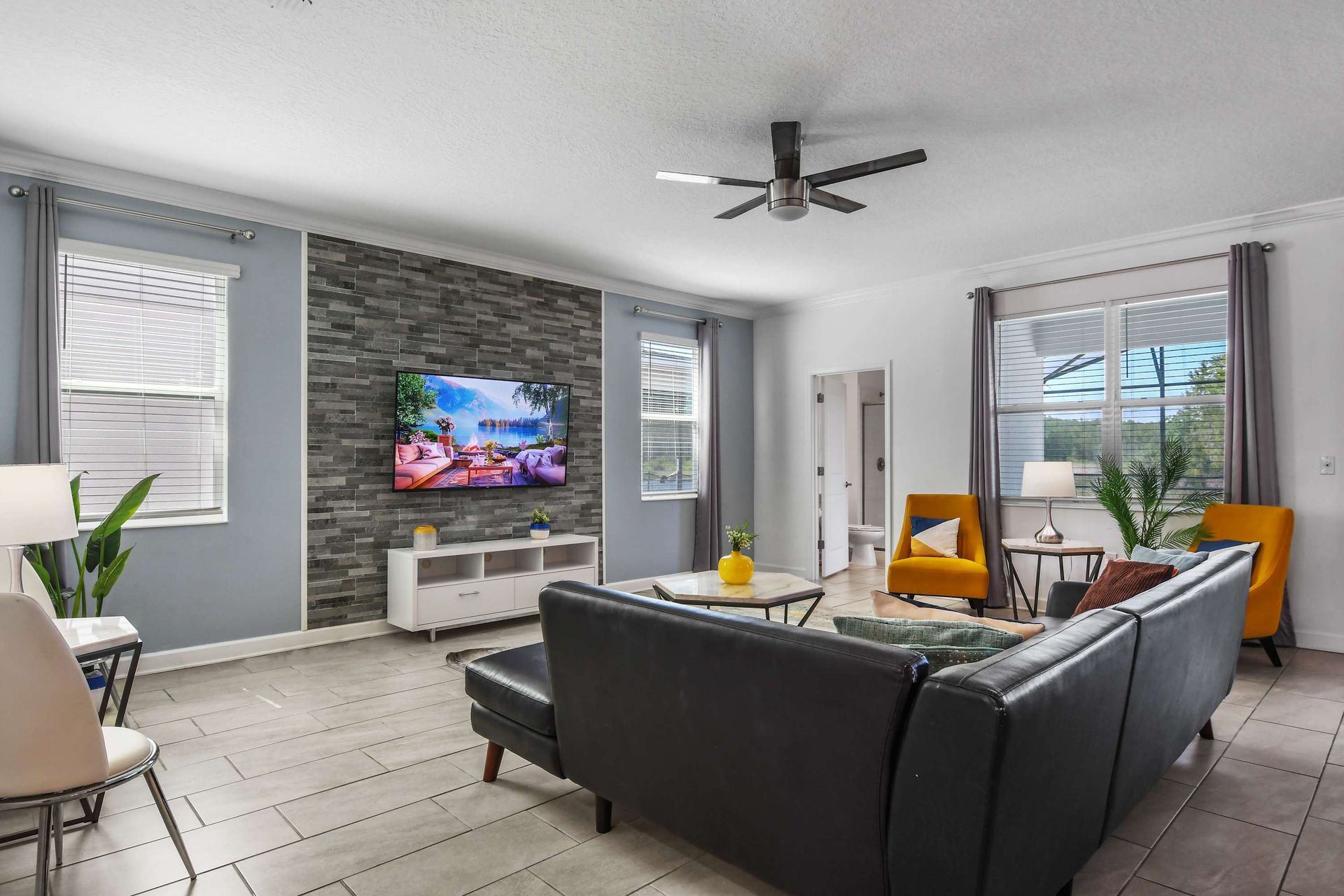 Modern living room with a stylish accent wall, cozy seating, and a relaxing ambiance.