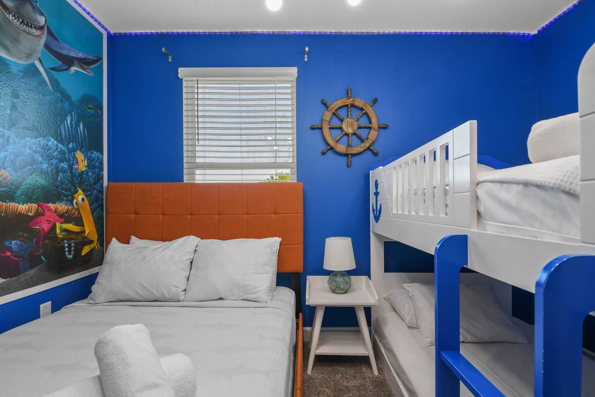 Ocean-themed bedroom with vibrant decor, cozy beds, and a fun undersea adventure vibe.
