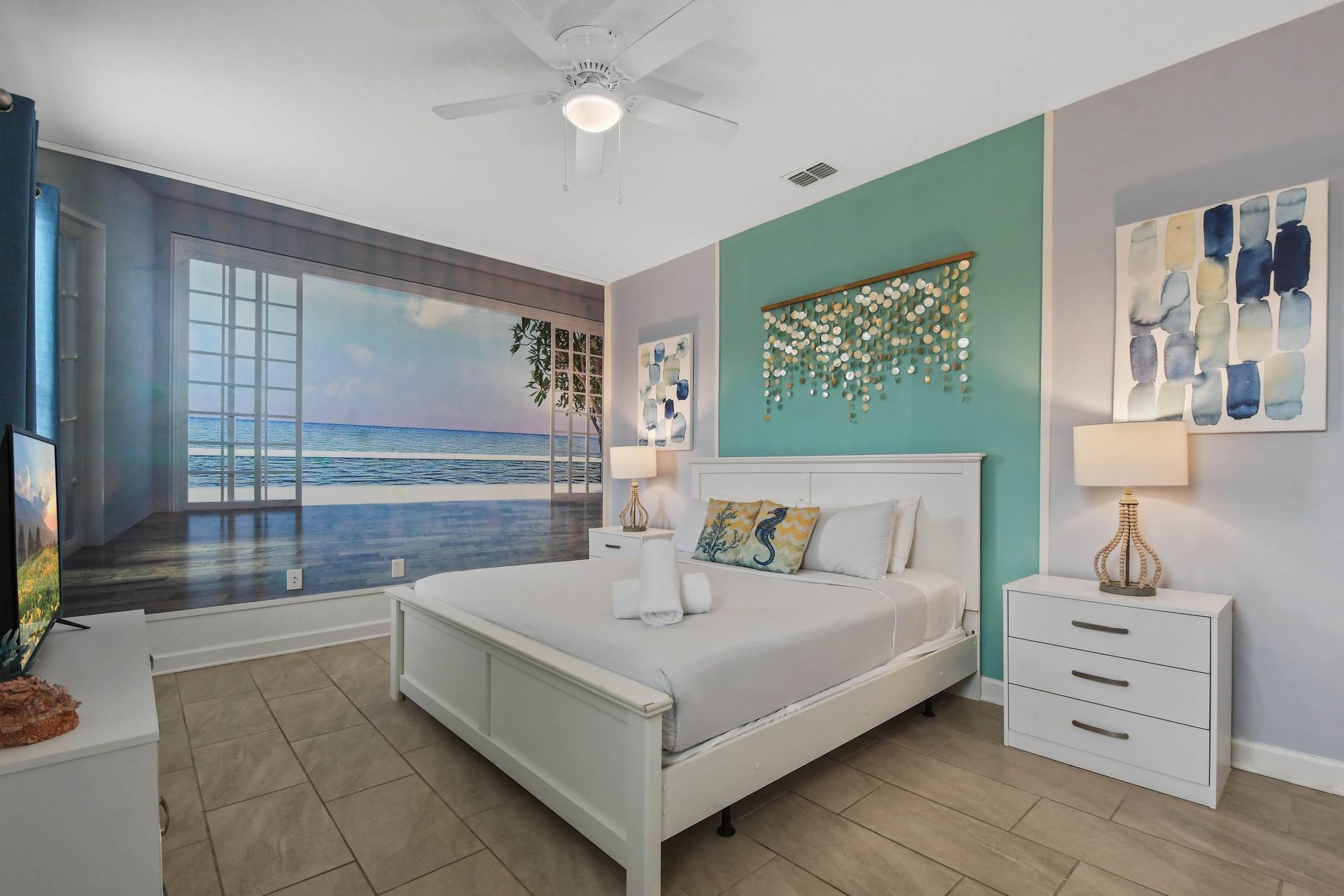 Serene coastal-themed bedroom with elegant decor, a king bed, and a relaxing vibe.