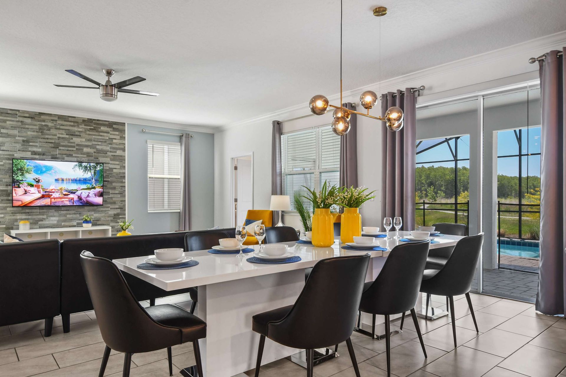 Elegant dining space with modern decor, stylish lighting, and scenic pool views.