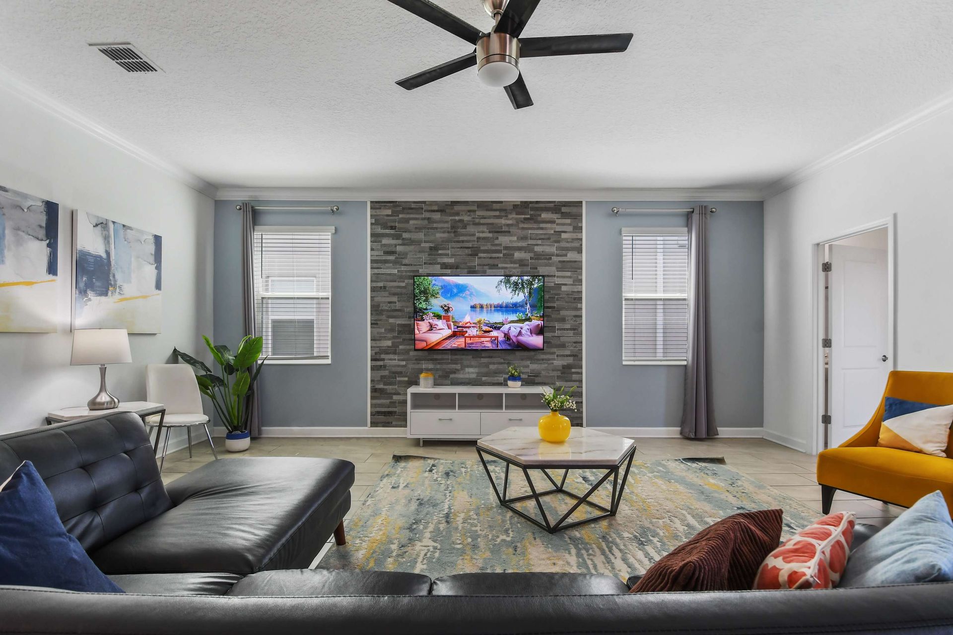 Stylish living room with modern decor, cozy seating, and a sleek entertainment setup.