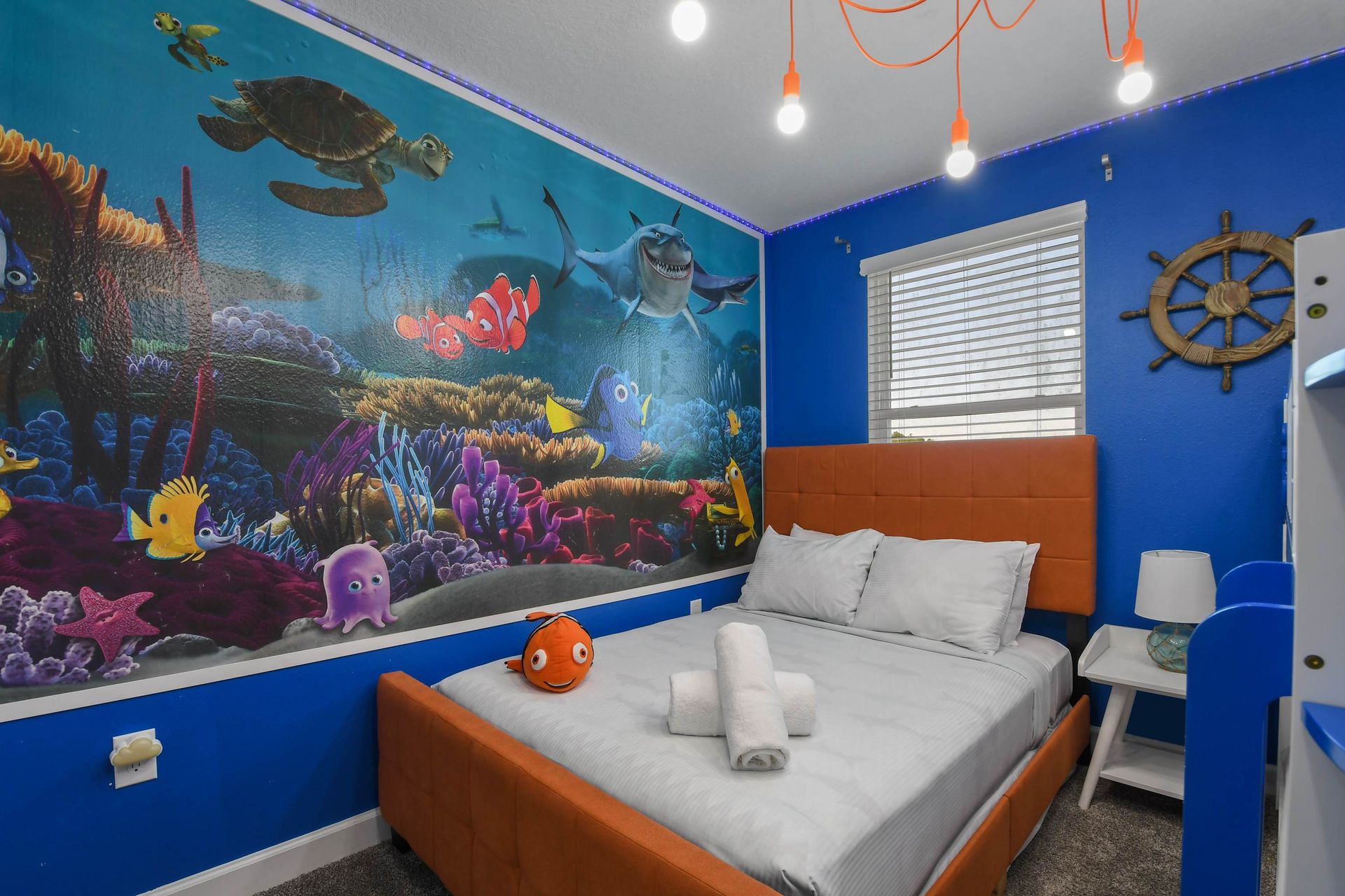 Ocean-themed bedroom with vibrant decor, cozy beds, and a fun undersea adventure vibe.