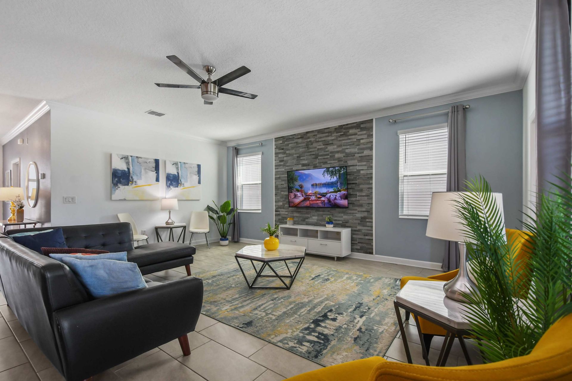 Modern and stylish living room with cozy seating, sleek decor, and a smart TV.