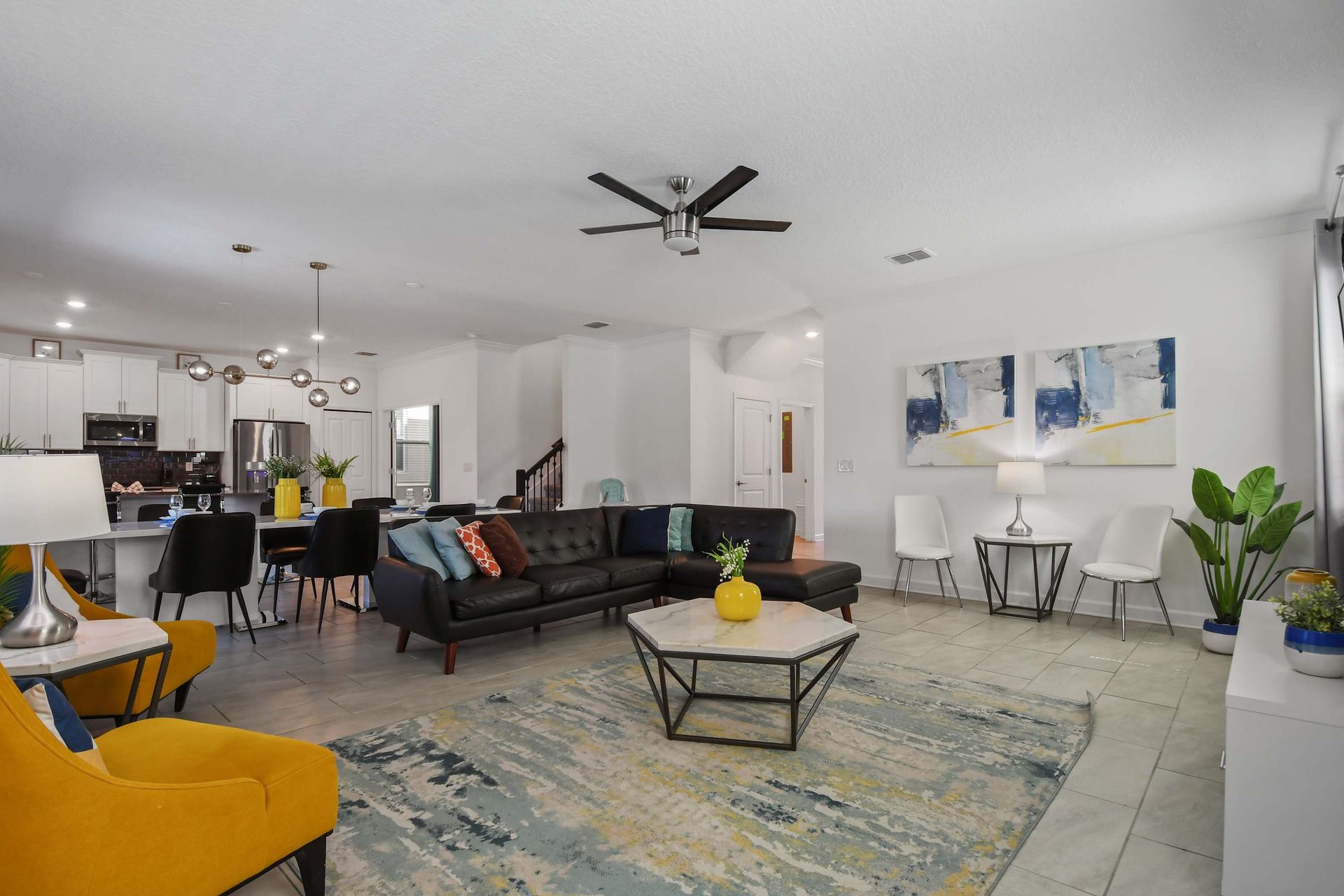 Modern open-concept living space with stylish decor, cozy seating, and natural light.