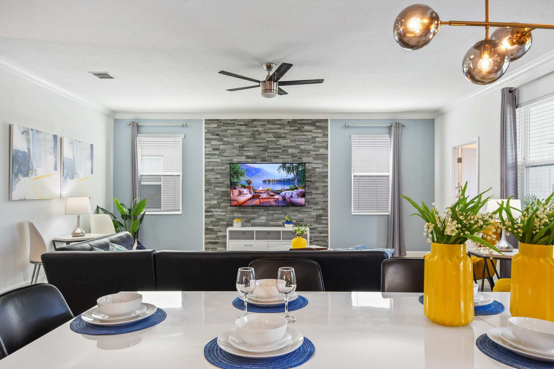 Modern kitchen with sleek appliances, white cabinetry, and a spacious island with seating.