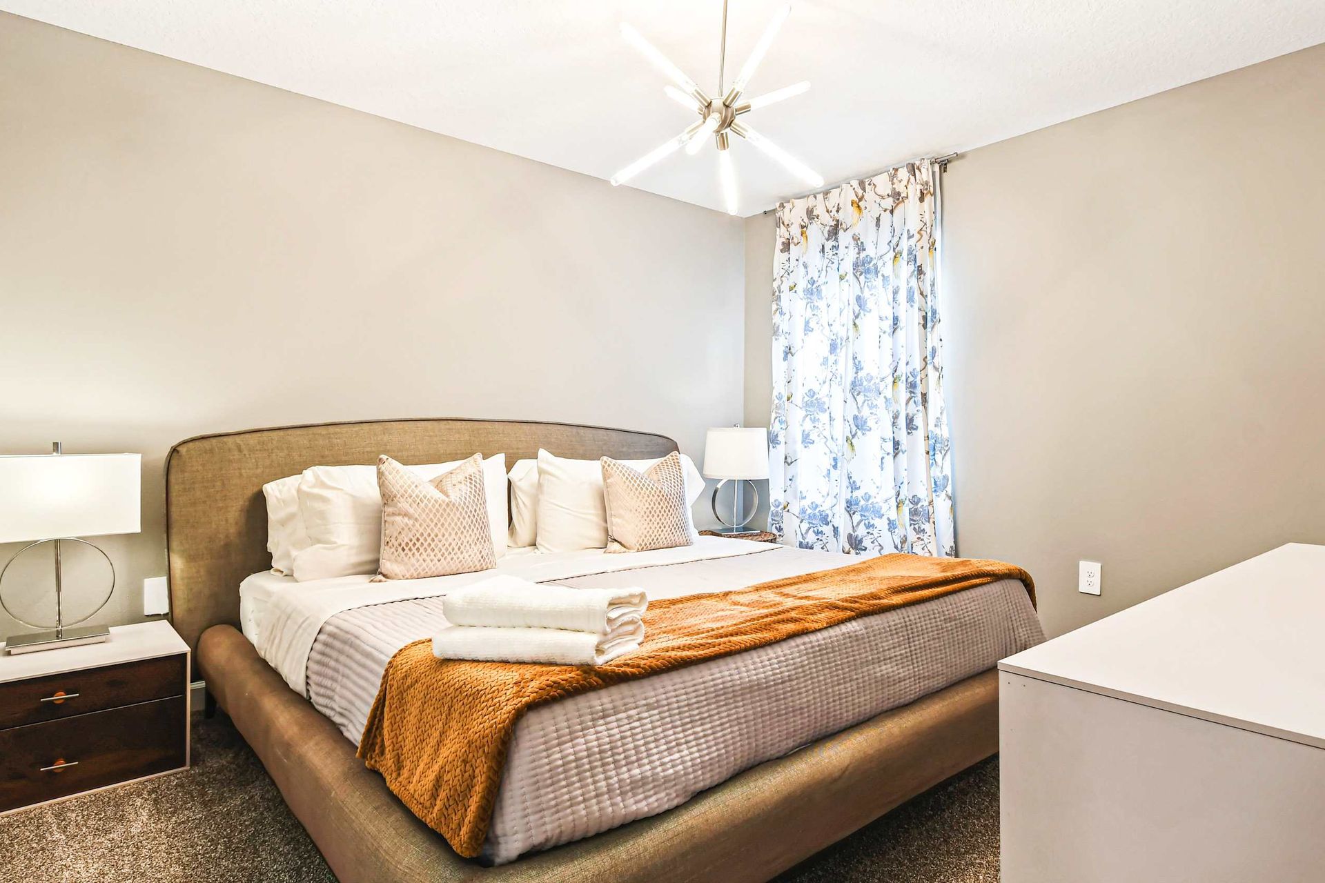 Serene bedroom with soft neutrals, elegant decor, and a plush king-size bed.