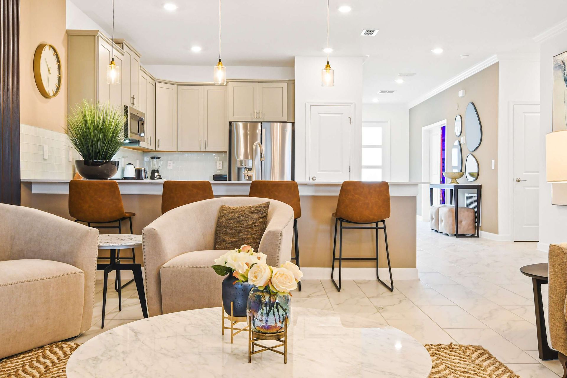 Stylish open-concept living space with a modern kitchen, cozy seating, and decor.