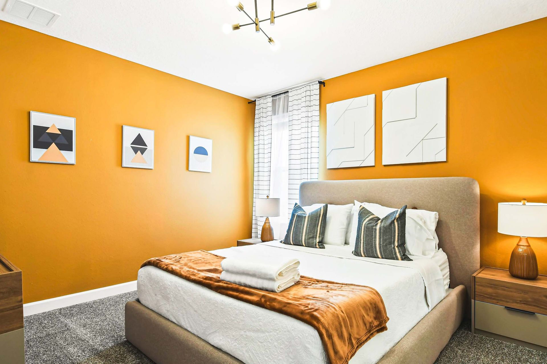 Modern bedroom with bold accent wall, cozy king bed, and stylish geometric décor
