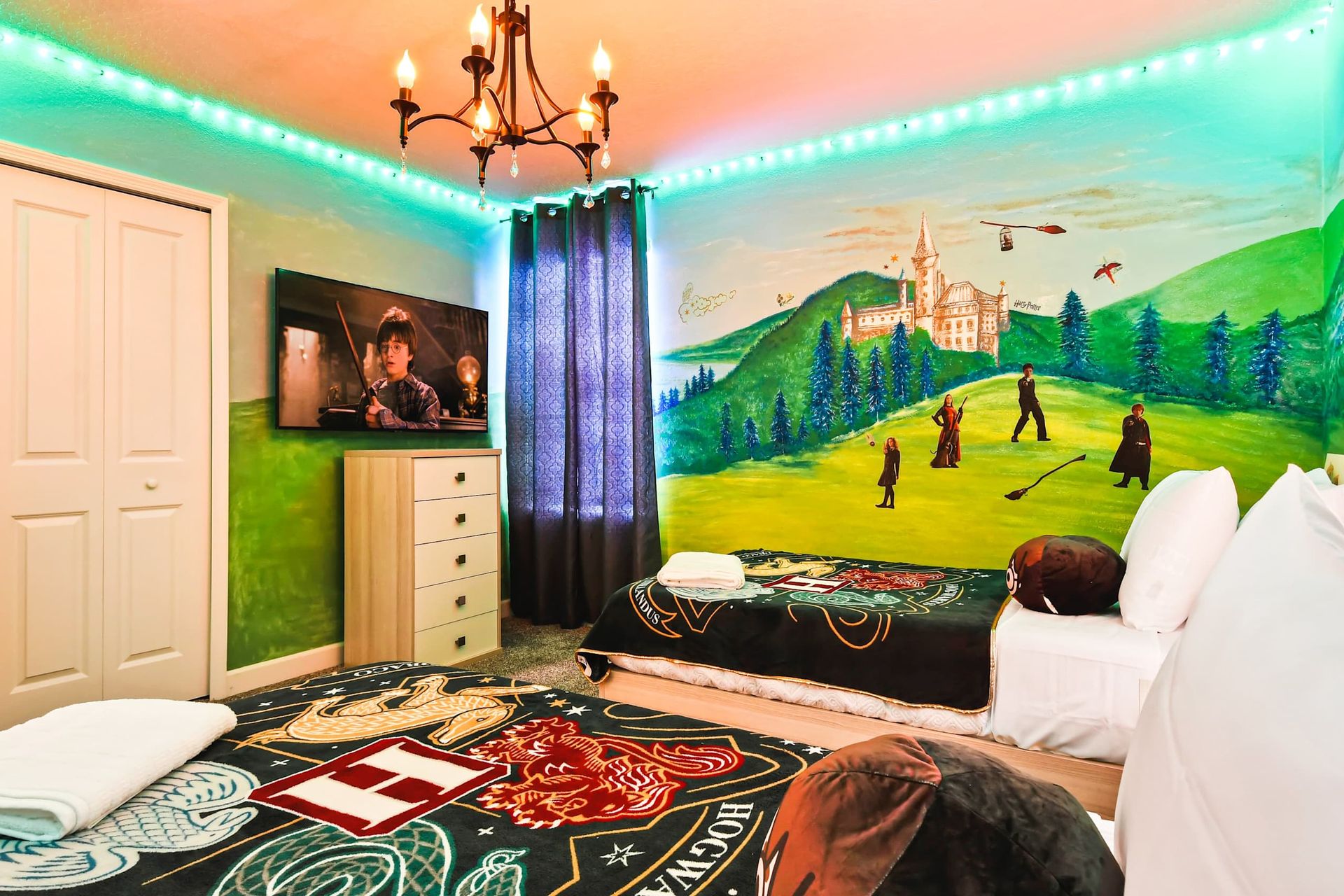 Magical Harry Potter-themed room with murals, cozy beds, and enchanting decor.