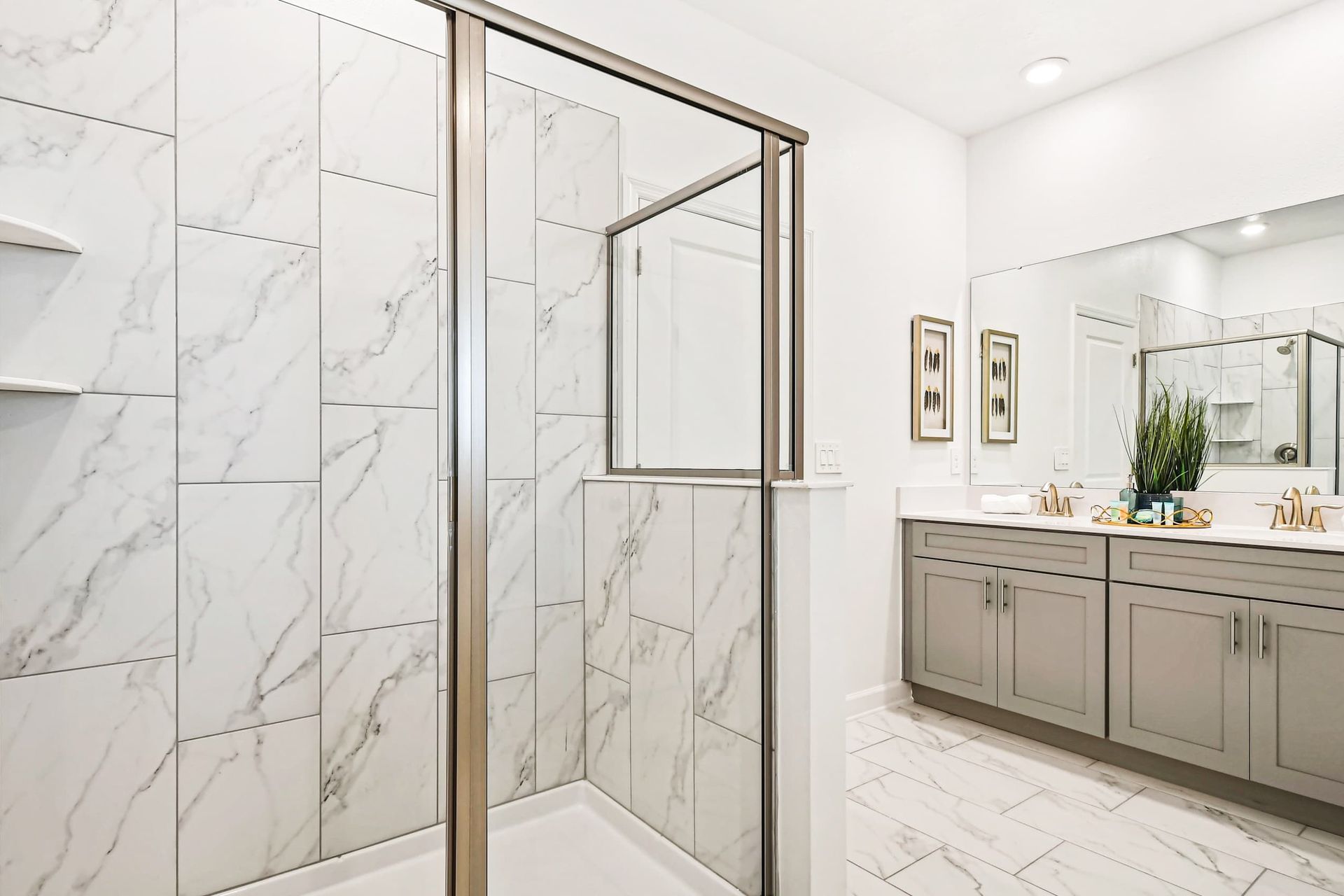 Elegant bathroom with a marble walk-in shower, double vanity, and modern finishes.