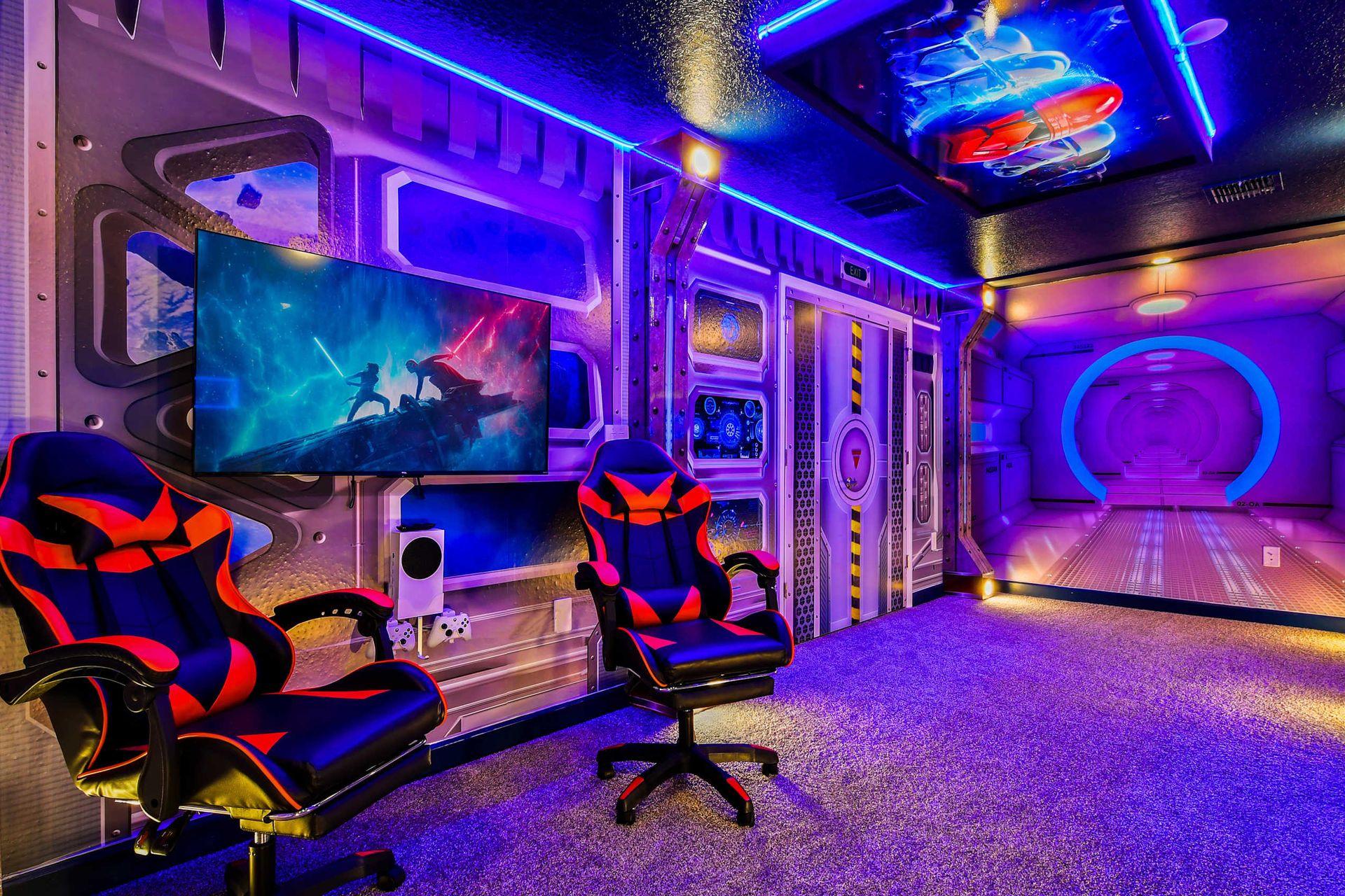 Futuristic space-themed room with glowing LED lights, gaming setup, and bunk beds.