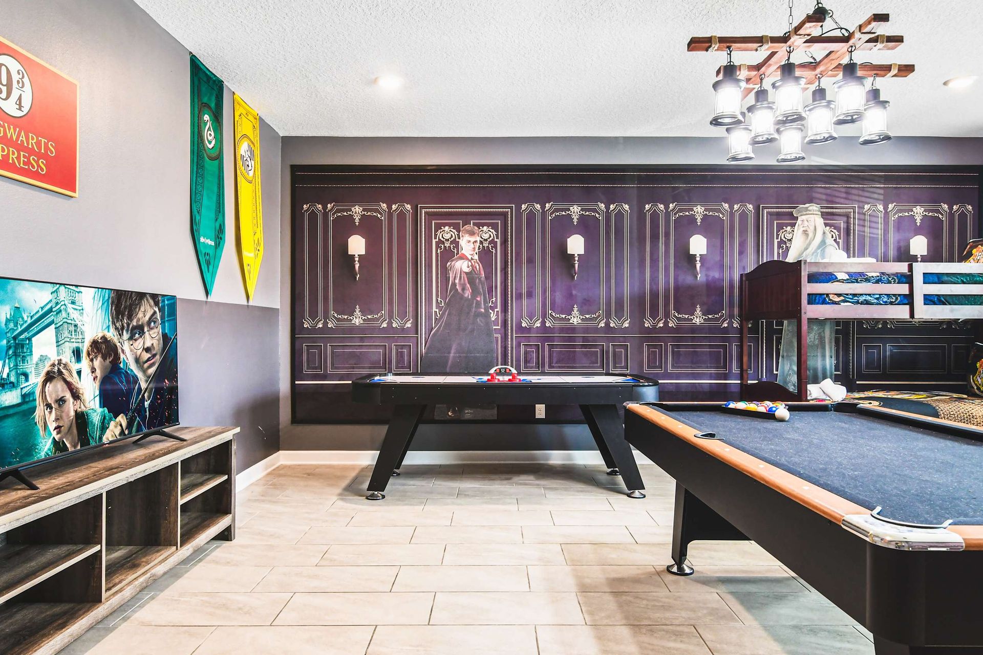 Enchanting game room with wizard decor, bunk beds, pool table and air hockey
