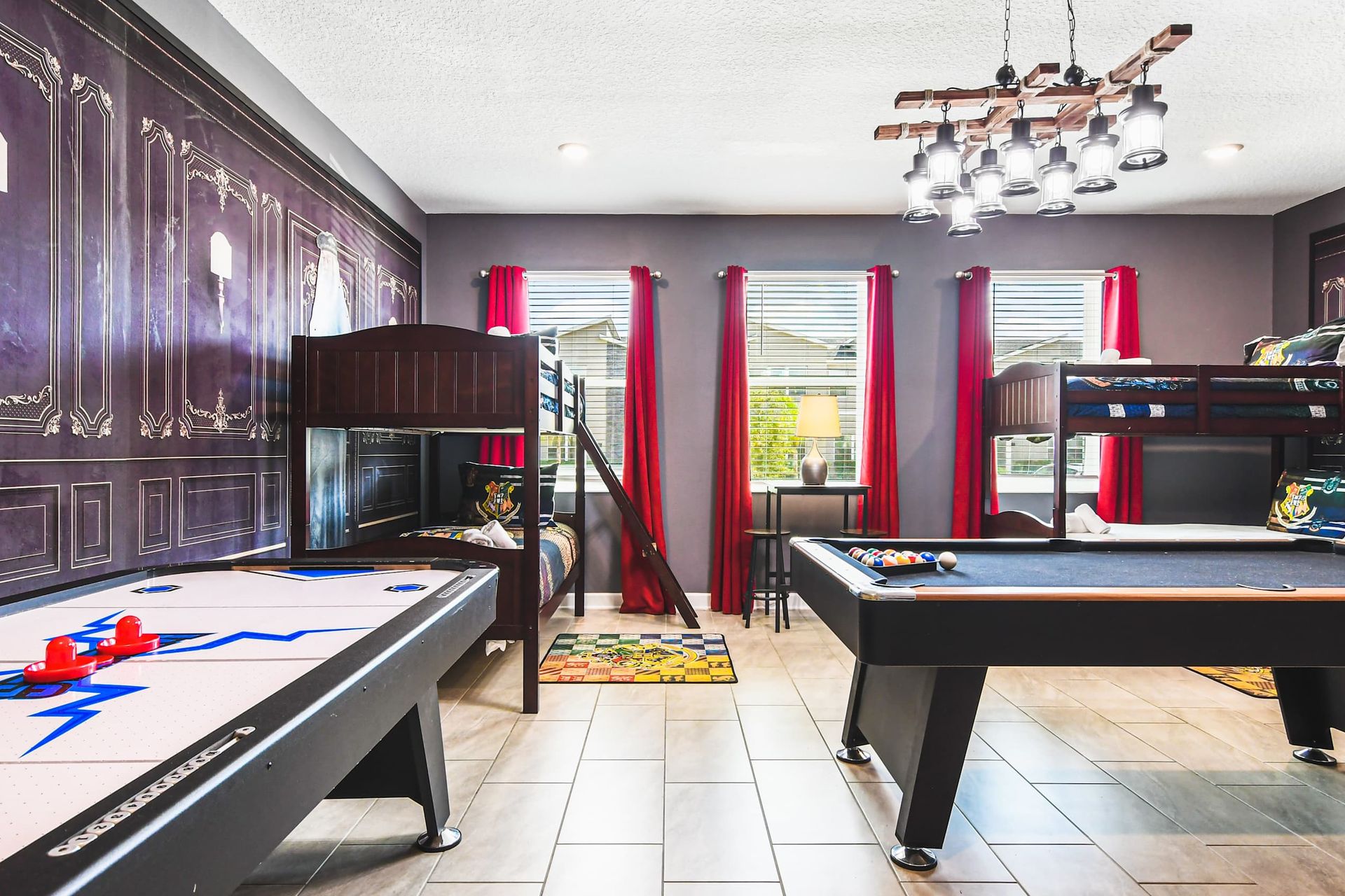 Magical game room with themed bunk beds, pool table, air hockey and fun decor
