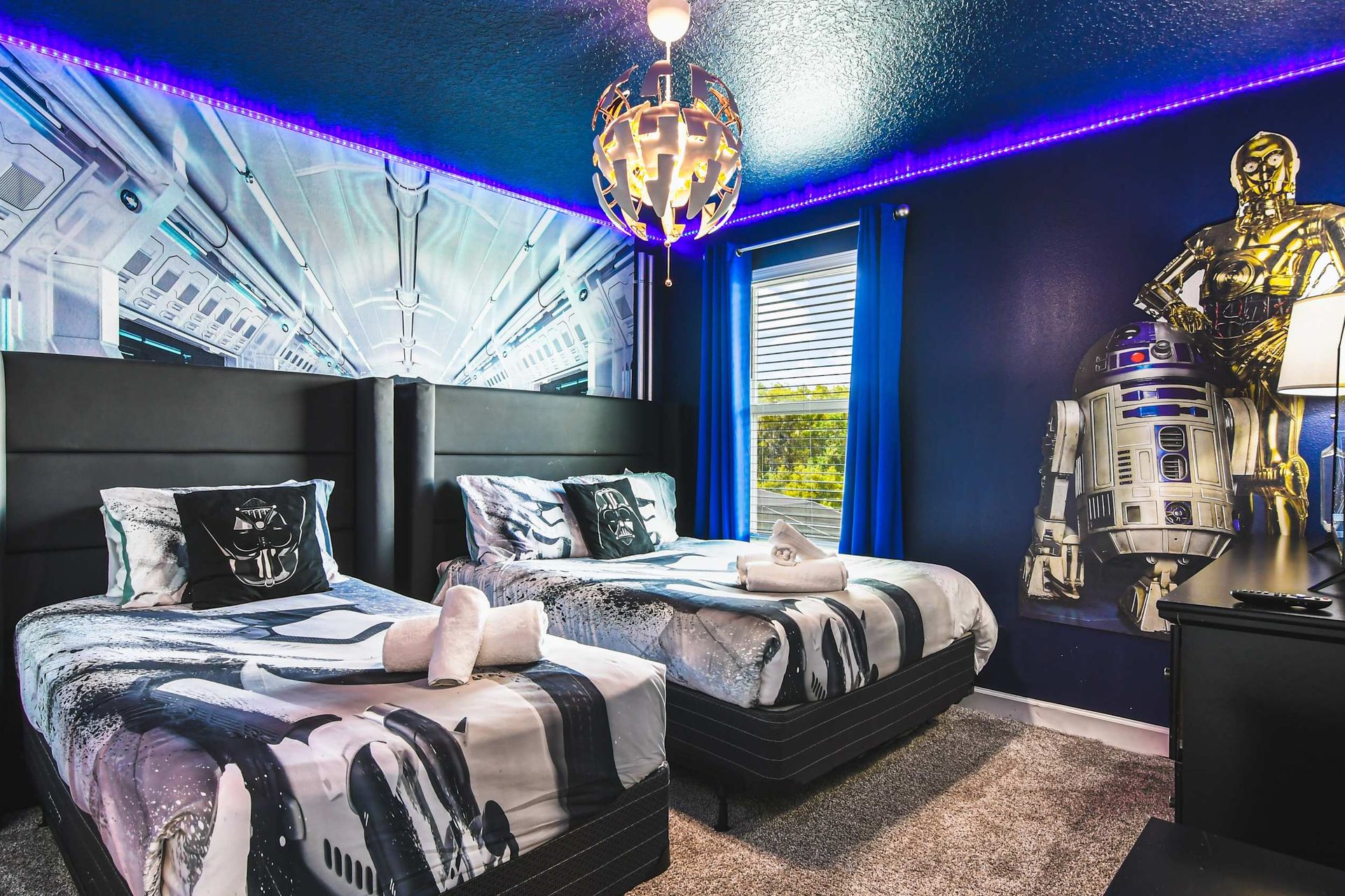 Epic galaxy-themed room with twin beds, cool lighting, star decor and movie vibe
