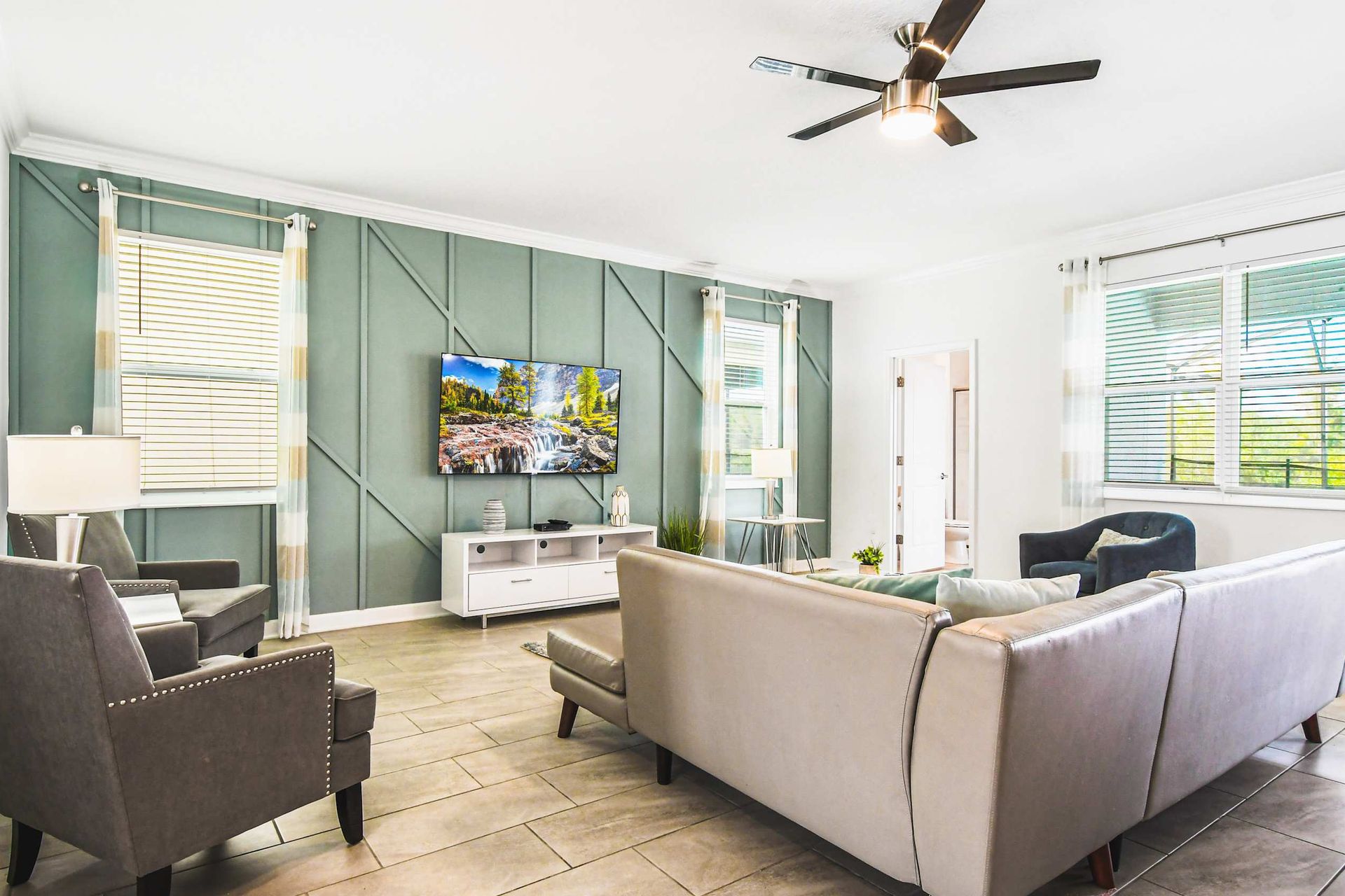 Bright modern living room with comfy seating, smart TV, stylish decor and light vibes
