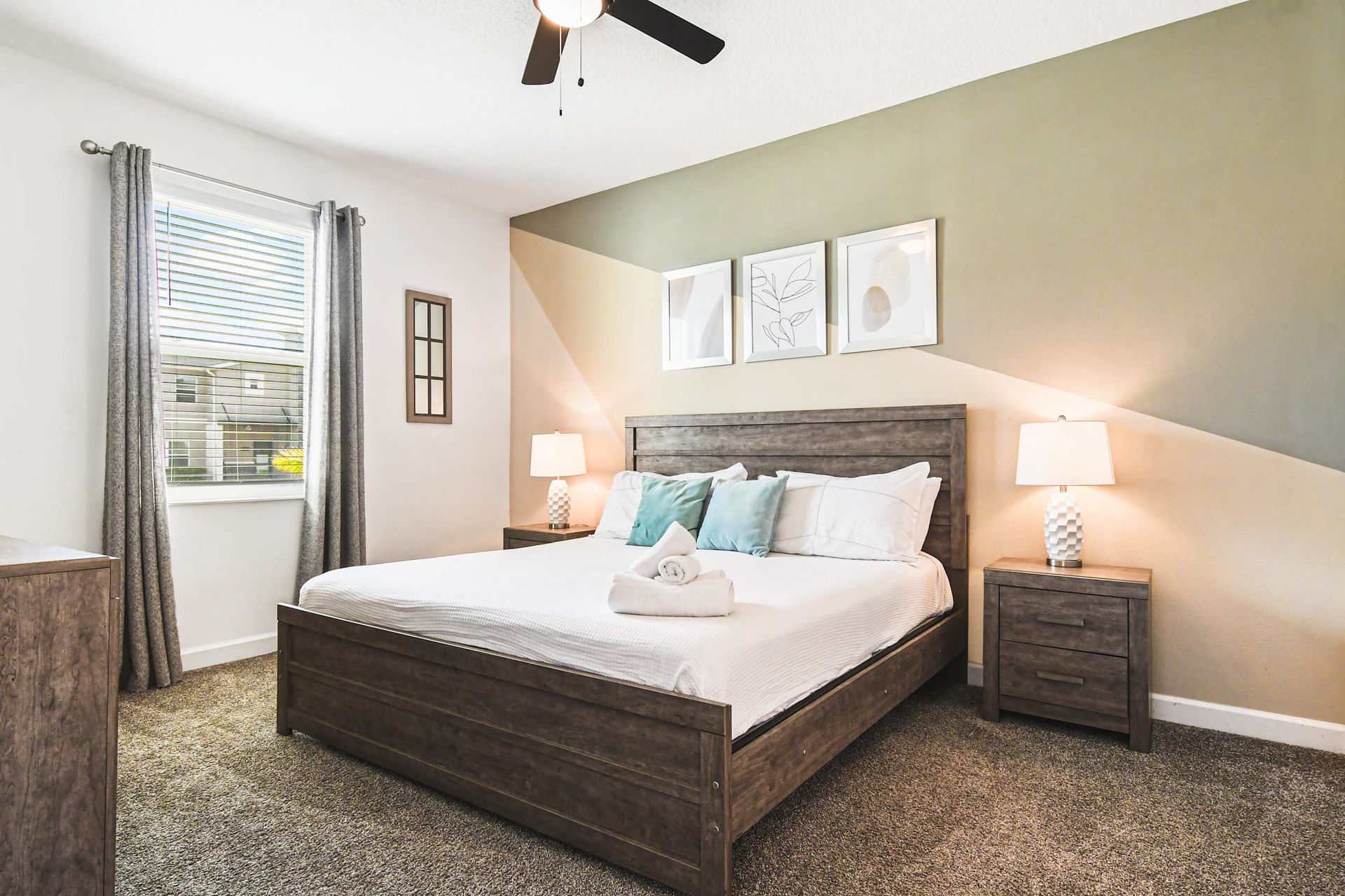 Modern bedroom with king bed, unique accent wall, cozy vibe and lots of natural light
